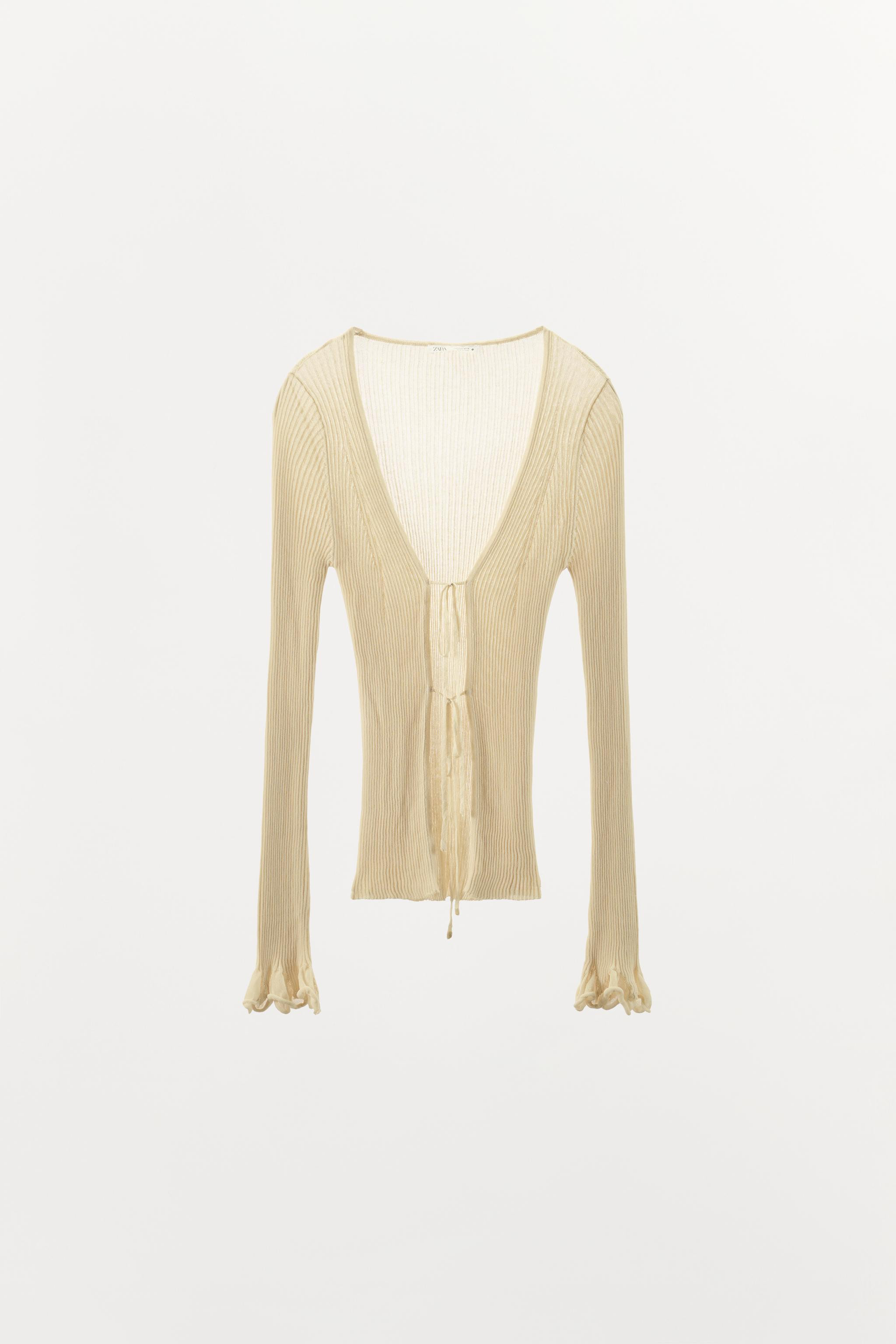 Knit cardigan with a V-neckline, long sleeves with ruffled cuffs and ribbed trims. Front fastenin... | Zara UK