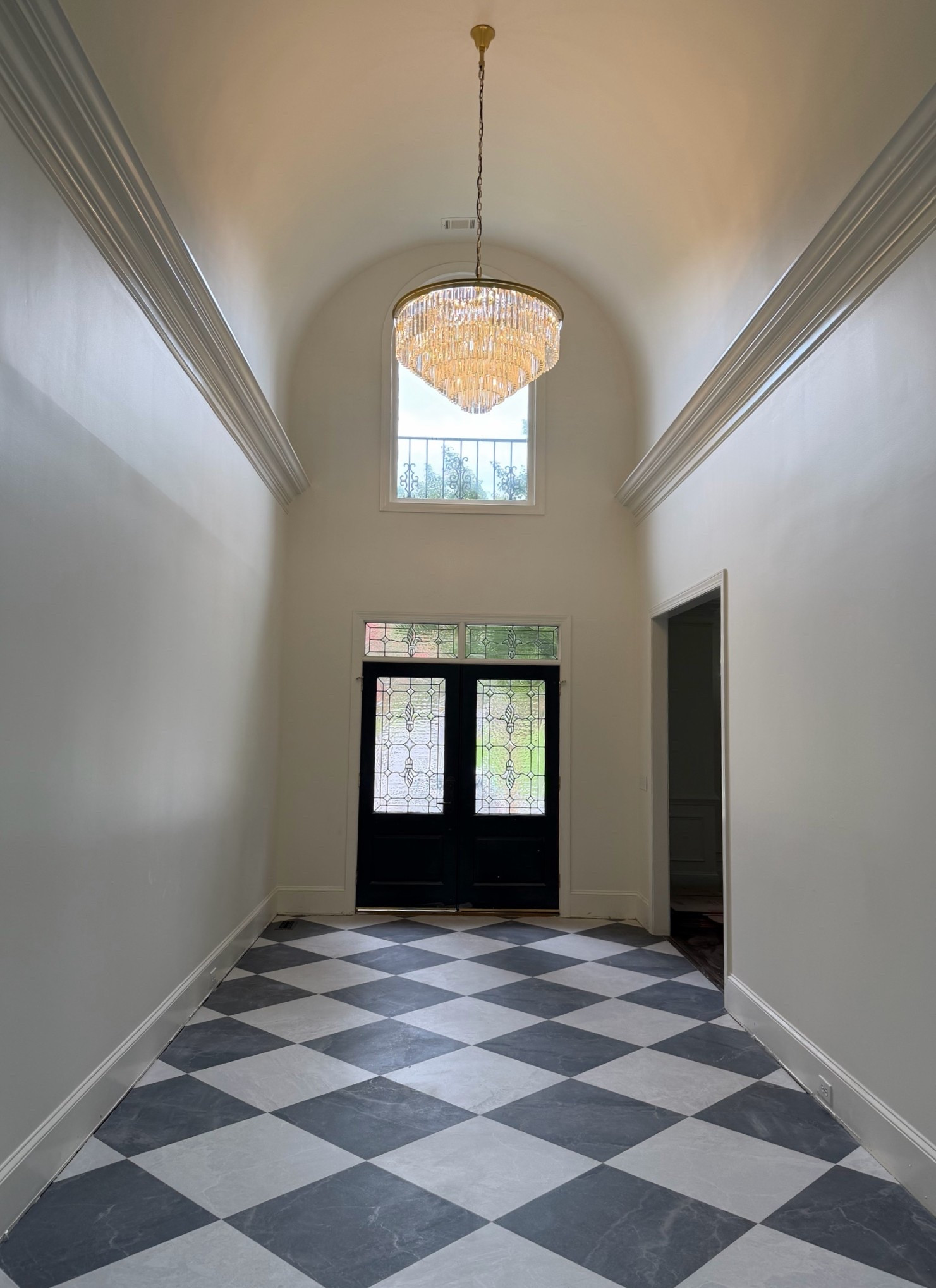 Black and white checkerboard foyer with crystal chandelier. 
Black and white checkerboard tile floor

#LTKHome