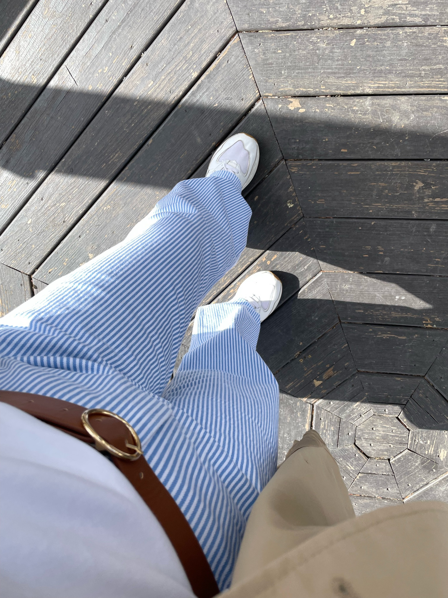 Striped jeans, white and blue jeans, white and blue striped pants, brown belt, white tee shirt, trench coat  

#LTKfindsunder100 #LTKmidsize #LTKstyletip