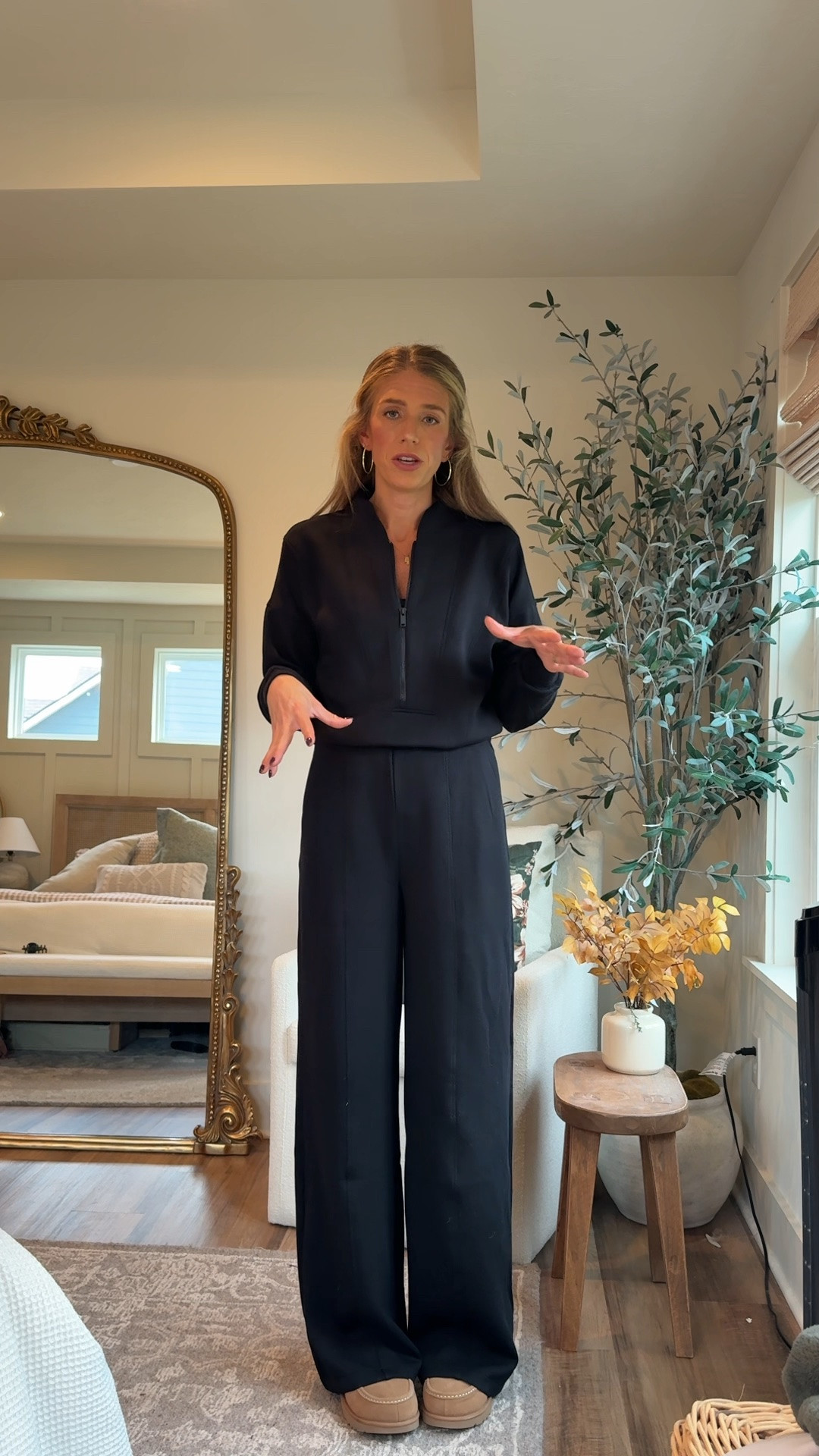 I am in love with this Spanx jumpsuit. It is tall girl, friendly. I am wearing size small tall. It is made of the softest material and you can pull down the back to go to the restroom without having to takeoff the entire jumpsuit.
