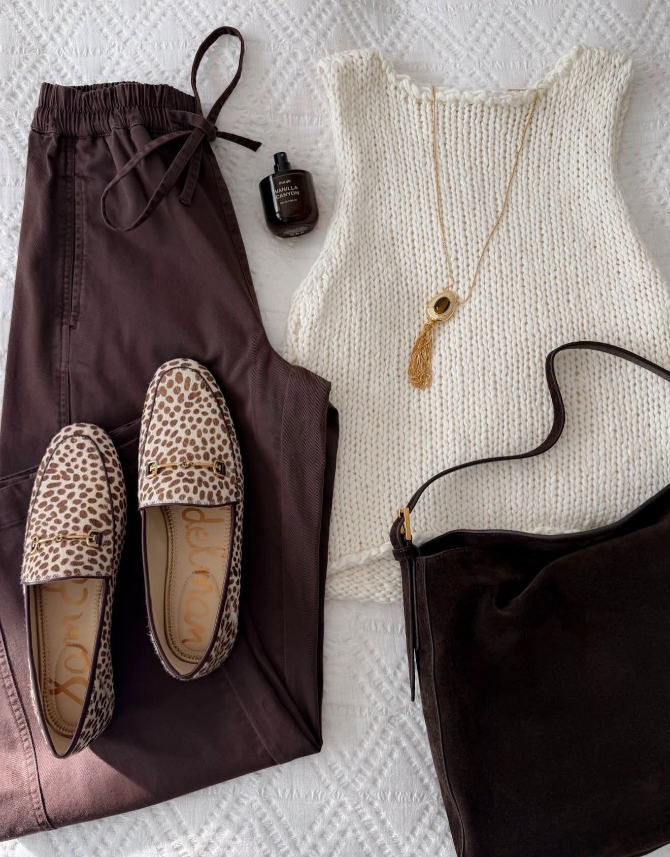 Chocolate brown and cream is such a good fall combination, especially with a little leopard mixed in. The chunky knit tank keeps it wearable while it’s still warm, and the spotted loafers give the whole look more personality.

chocolate brown pants, knit tank, leopard loafers, fall outfit, transitional style, neutral fall outfit, brown suede bag, casual fall fashion, women’s loafers, early fall outfit, annabrstyle

#LTKootd #LTKSeasonal #LTKOver40