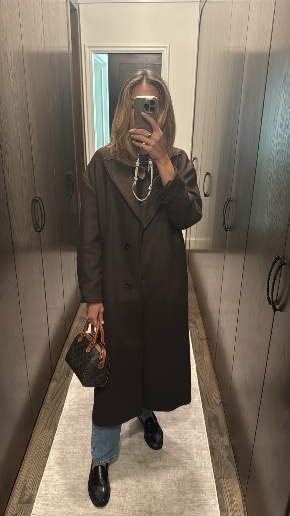 Long brown oversized coat (wearing a small) and Row-coded loafers 