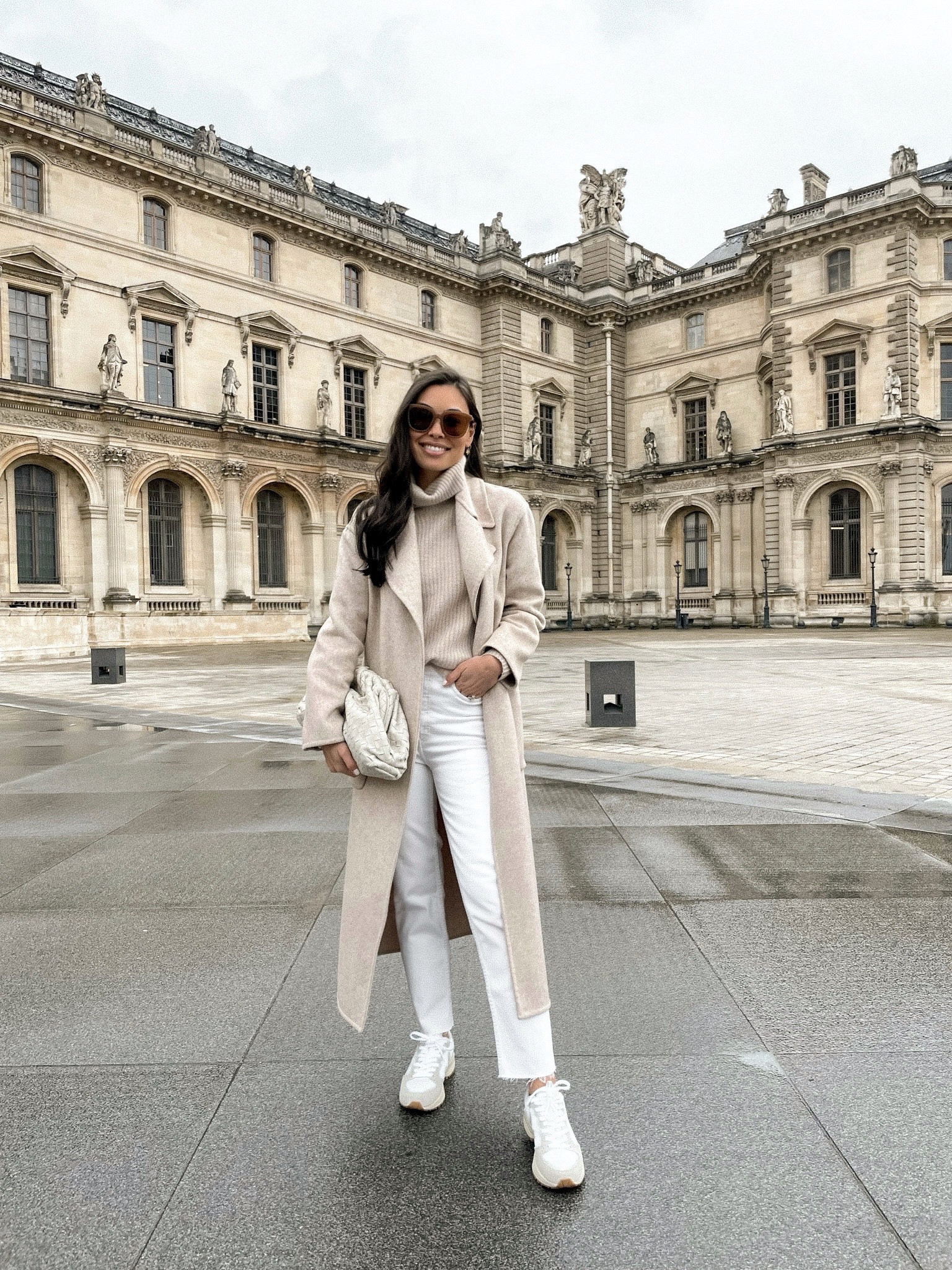 Kat Jamieson of With Love From Kat wears a winter outfit. Light beige coat, cashmere sweater, cream denim, white sneakers, woven clutch, neutral style, classic style.

#LTKshoecrush #LTKSeasonal #LTKstyletip