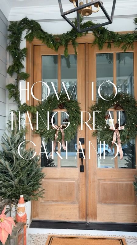 the halls are officially decked ✨🧑🏼‍🎄 I love using real greenery outside when decorating my front porch for christmas 🎄 I use cedar garland above my door + real 3ft christmas trees & fresh poinsettias, sharing my tips below ⬇️ 

+I use 3 strands of garland 
+start by placing the first in the center of your doorway
+add each strand from the center and hang on either side
+I use a mix of command hooks + nails 
+string your lights & your done 

-save + share for christmas inspo 🫶🏼
#christmas #christmasdecor #christmasdecorating #christmaswreath #christmasgarland #christmaslights #frontporchdecor #christmasideas #tistheseason 

#LTKHoliday #LTKhome #LTKSeasonal