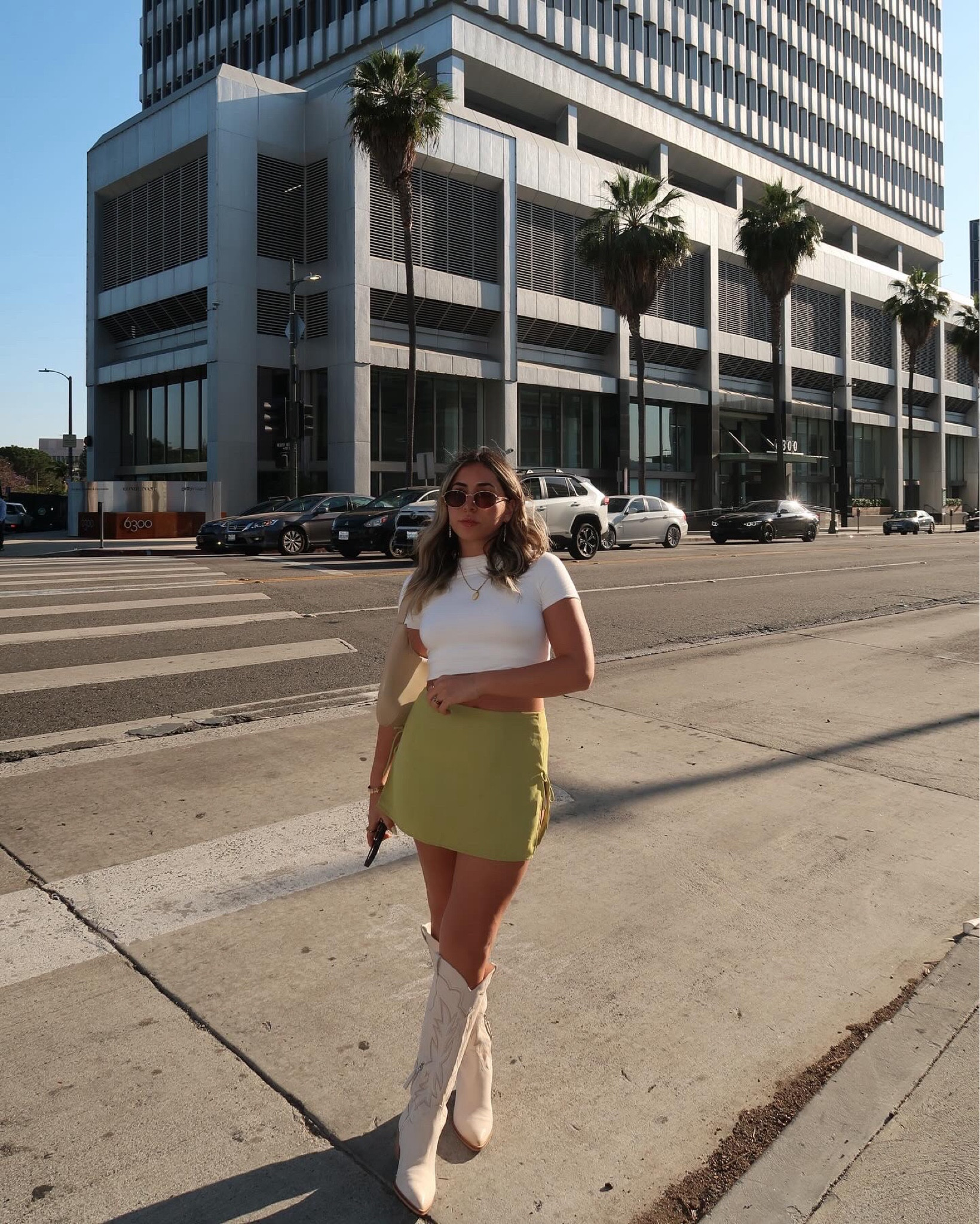 cowboy boots & mini skirts >> 
— green skirt, white tee, baby tee, cowboy boots, sunglasses 