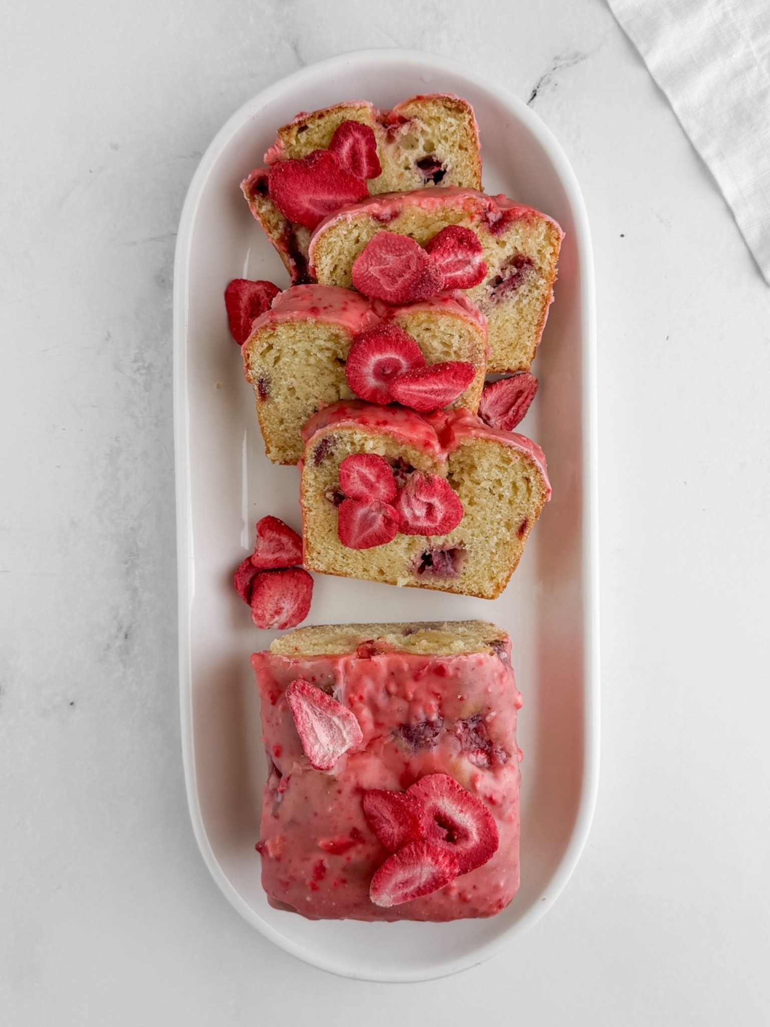 Strawberry Lemon Loaf Cake Fresh strawberries macerated and swirled into a tender sour cream batter, finished with a bright pink freeze-dried strawberry glaze. Use the 8x4 pan - it makes all the difference. Everything is linked here. Full recipe at sherisilver.com

#LTKfoodie #LTKSeasonal #LTKHome
