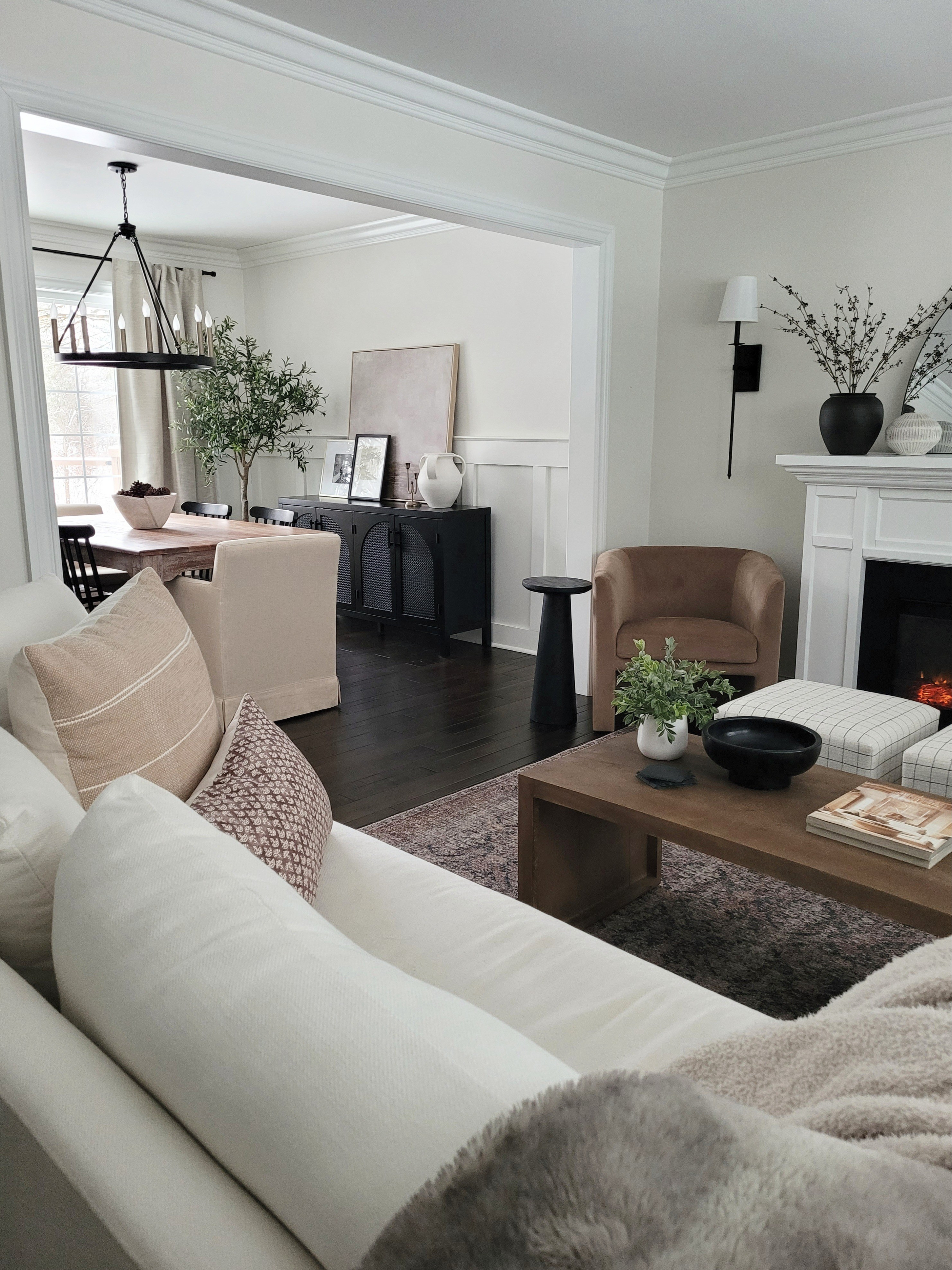 Living room dining room inspo with lots of Amazon home finds! Coffee table,  black arch cabinet,  buffet,  electric fireplace,  dining room chandelier,  upholstered chairs,  barrel chair,  vintage inspired rug, and oversized sconces!

#LTKHome #LTKSaleAlert