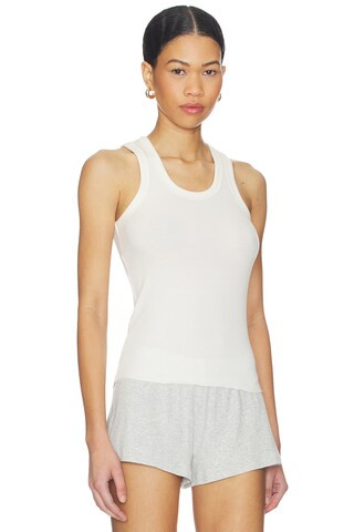 Cotton ribbed tank top with a low neckline.
                    
                    SKIMS | Revolve Clothing (Global)