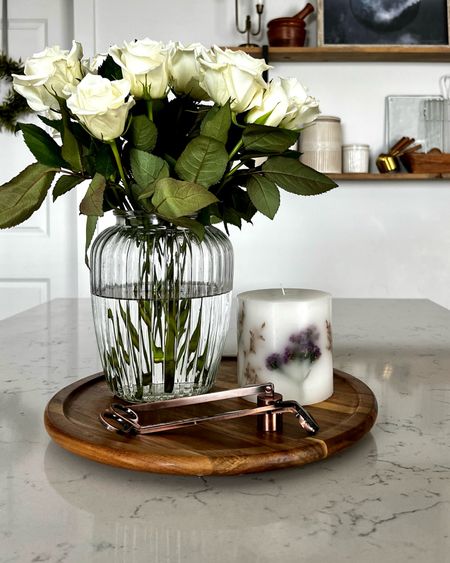 Picked up this beautiful ribbed glass vase at Michael’s for 40% off today, and this pretty pressed flower botanical candle was 70% off. Such a score, and my countertop looks so fresh!

Wooden lazy susan 
Candle wick trimmer kit
Kitchen counter styling
Kitchen shelf styling

#LTKunder50 #LTKSeasonal #LTKsalealert