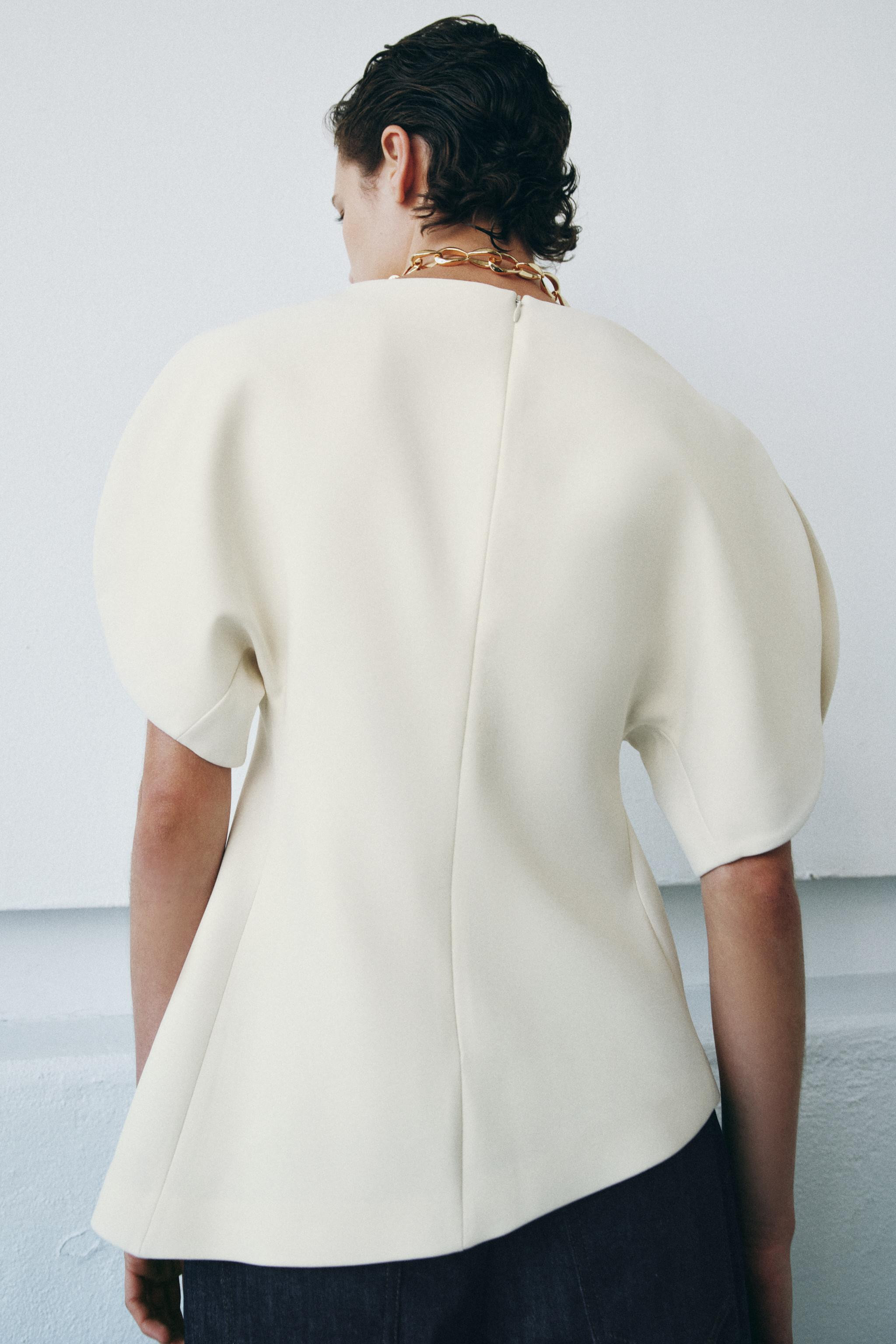 ZARA WOMAN COLLECTIONBoat neck top with balloon sleeves and vents. Asymmetric hem. Back hidden in... | Zara US