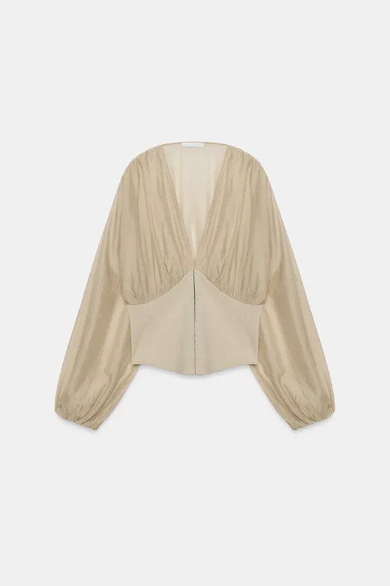 Model height: 175 cmV-neck top featuring long sleeves with elastic cuffs. Corset-style fabric det... | Zara UK