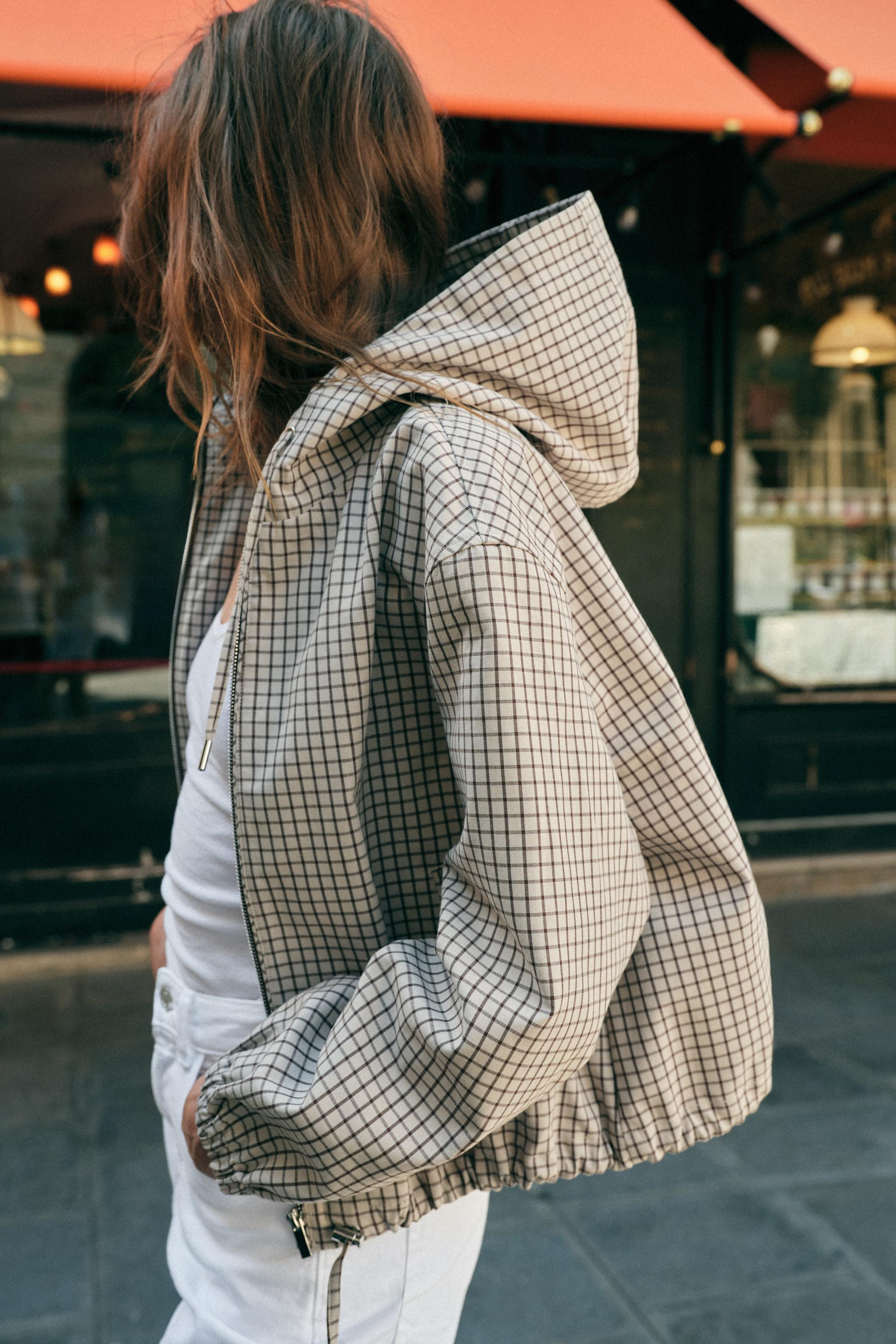 Jacket with adjustable drawstring hoodie and long sleeves with elastic cuffs. Double welt front p... | Zara US