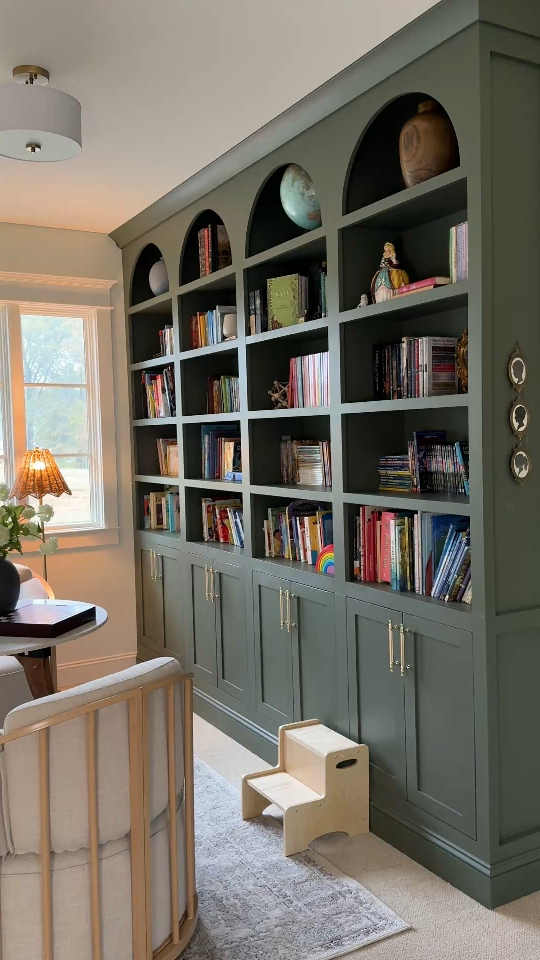Children’s Library in our upstairs loft featuring moody green arch bookshelves. 💚

#LTKHome