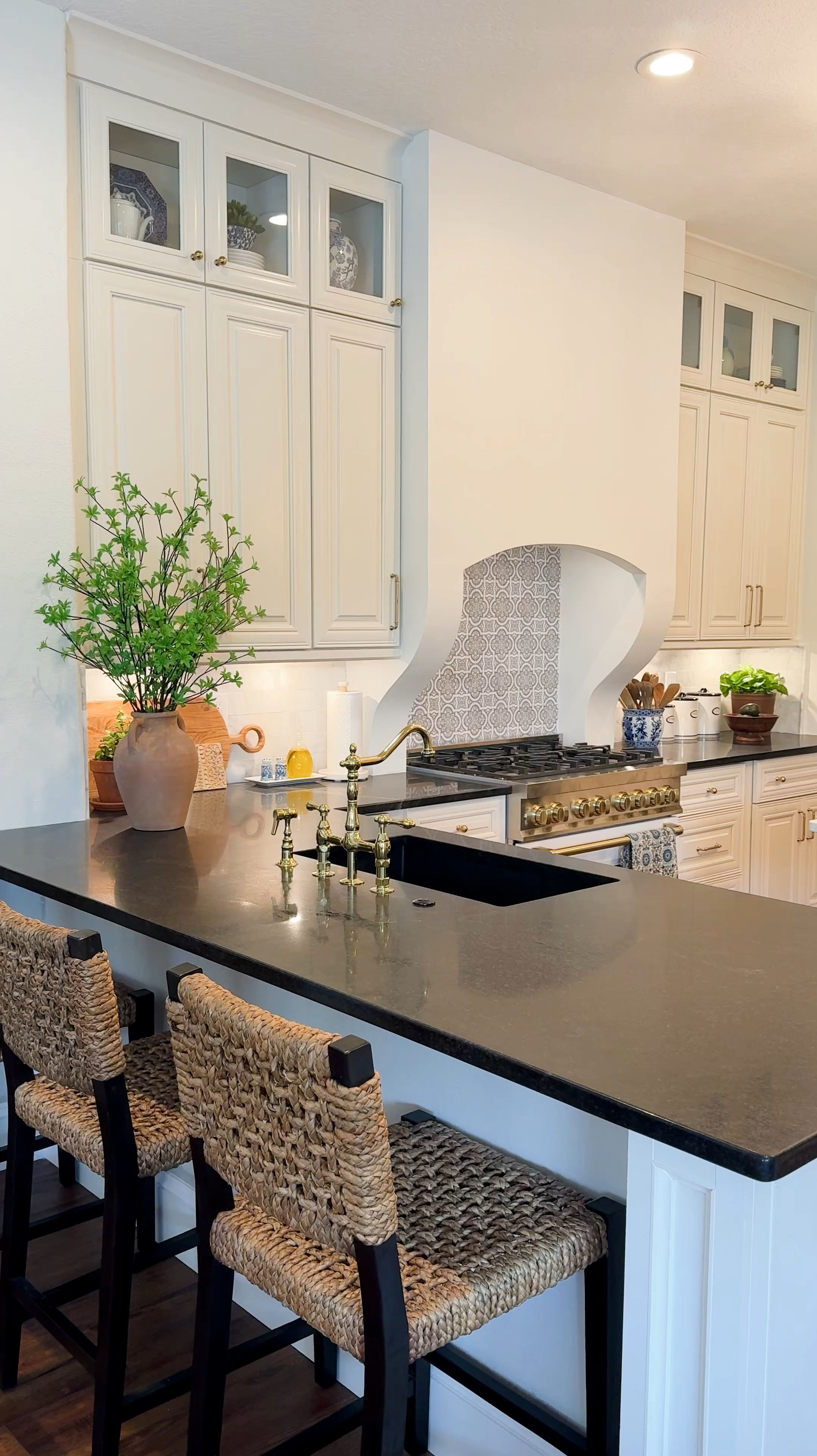 A few things to note: for the island, I customized the size to fit my space and order it in the dark walnut color (it’s almost black). I also opted to order it WITHOUT a countertop so that I could add the Dolomite and switched out the drawer pulls it came with.  The backsplash patterned tile is from Stone Impressions, it’s called Lena Winter Blue.  

The subway tile is a Carrara subway from Floor and Decor.  The backsplash behind the stove is from Stone Impressions, “Lena, Winter Blue”. 

All other products are listed below.  Enjoy! 

Range, tile, lighting, faucet, barstools, backsplash, brass rails, kitchen decor