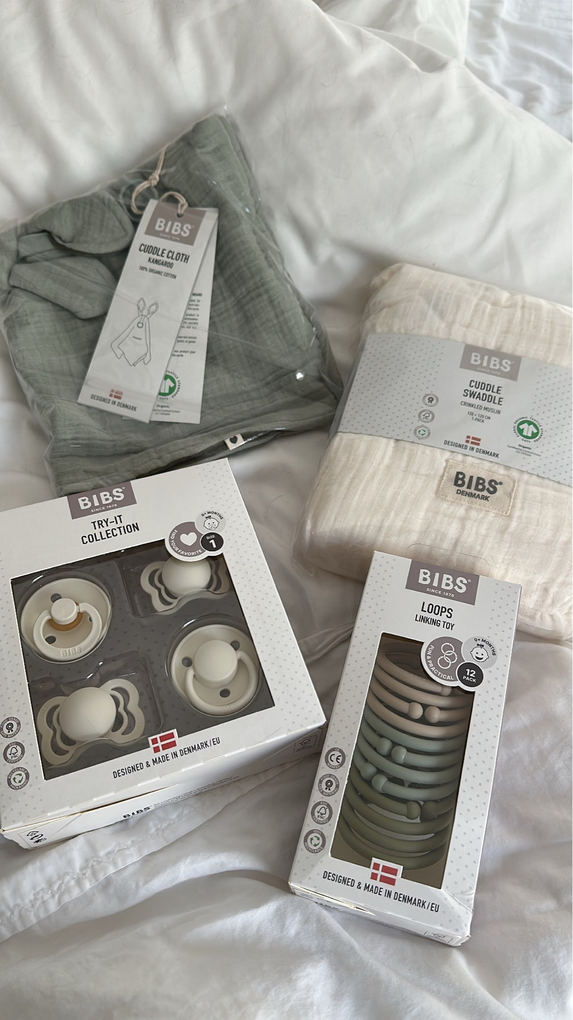 BIBS cuddle cloth, cuddle swaddle, try it out pacifiers bundle, and loops linking toy. 