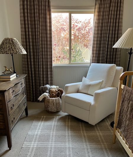 Neutral nursery styling 

Neutral spindle crib light natural wood upholstered glider white fabric check plaid throw pillow cover dark beige kilim stripe tan ivory pillow cover brown kantha quilt vintage framed art landscape vintage city brown rug Jellycat stuffed bunny doggy plaid drapery curtains vintage aged brass rocking horse arched mirror vintage childs chair iron floor lamp small faux tree pleated lamp shade floral black fabric kids woven rush seat chair vintage brass horse 

#LTKSale #LTKhome #LTKFind