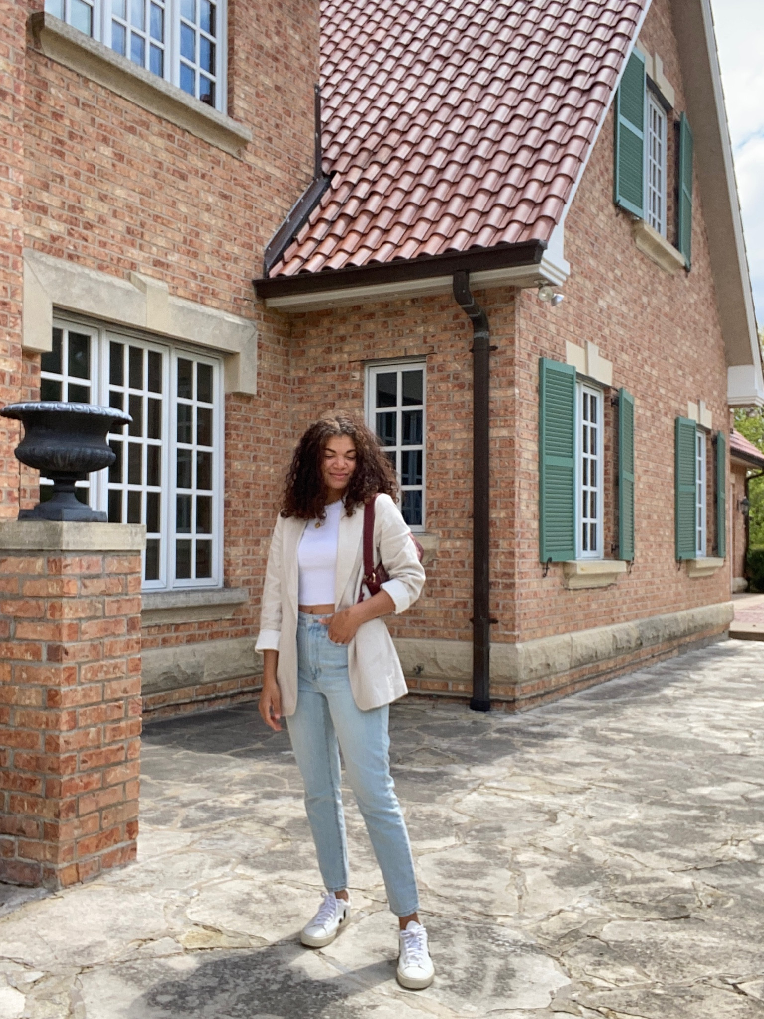 Weekend Saturday outfit of a white t-shirt, jeans, sneakers, and linen blazer 
