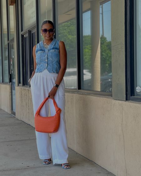 White linen pants and denim vest w/denim sandals. Add orange handbag for a pop of color 

#LTKStyleTip