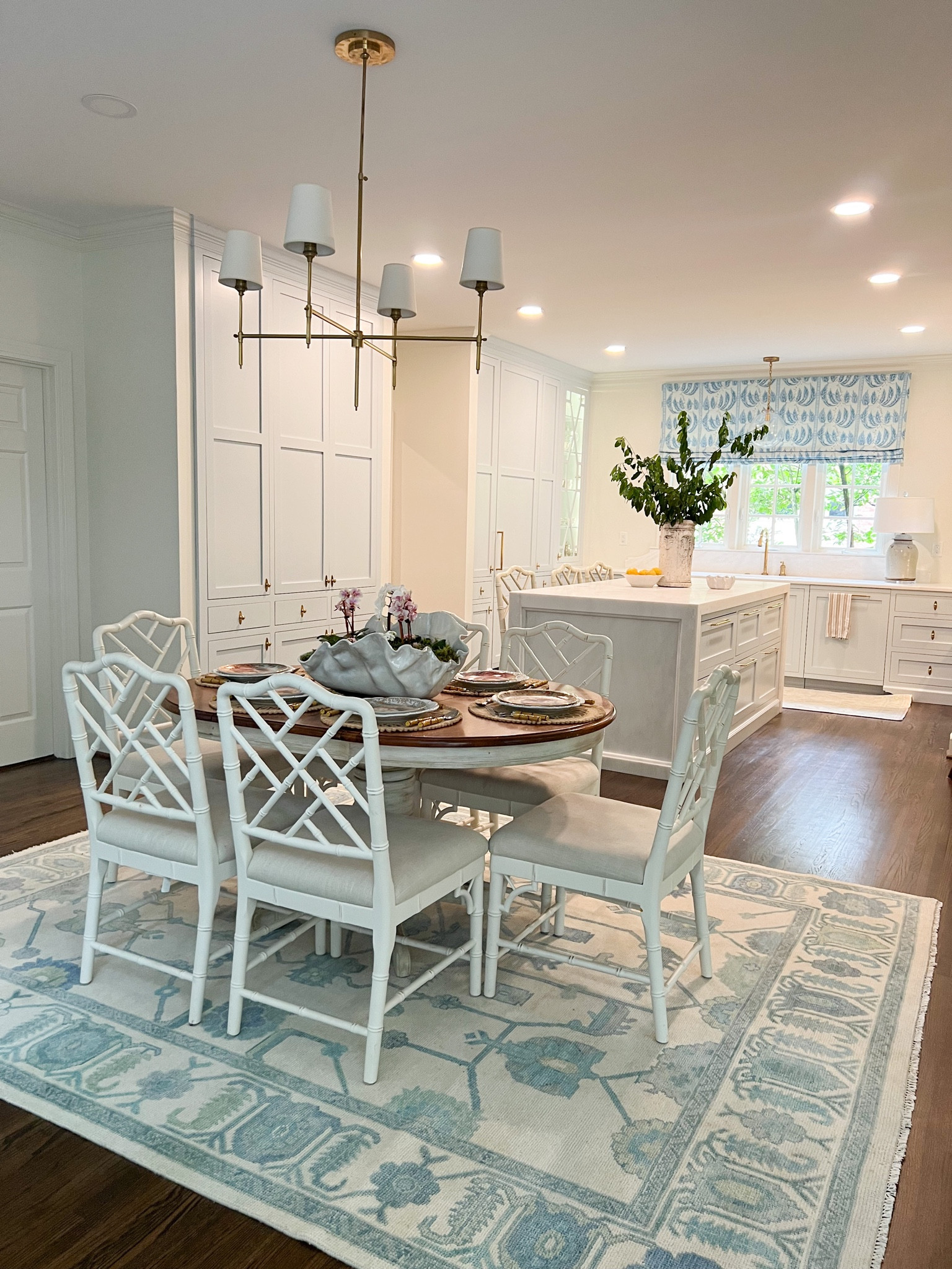 Kitchen breakfast room decor 

White chippendale dining chairs rattan oushak rug lighting curtain chandelier 

#LTKFind #LTKhome