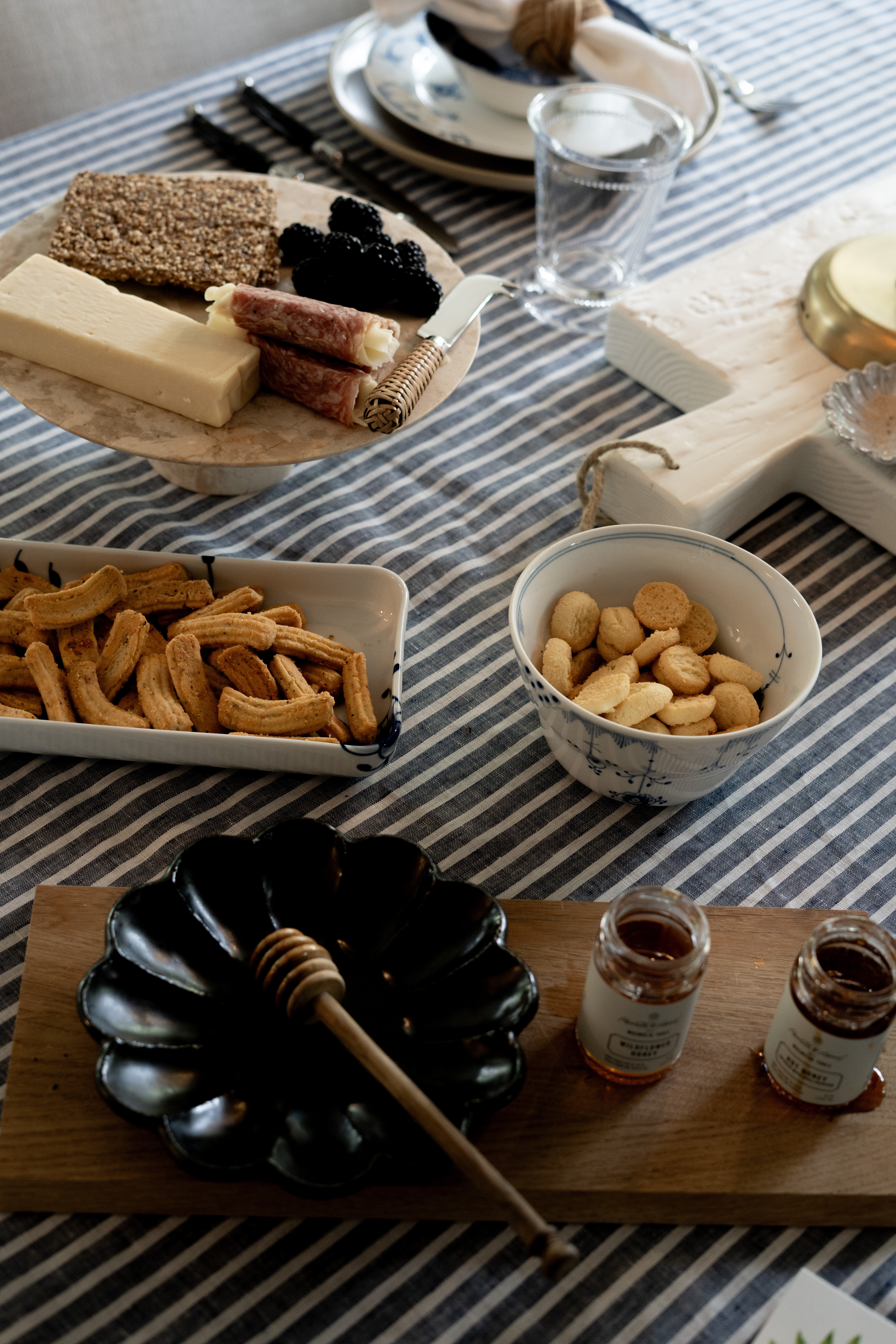 OMG this is my dream hosting setup!! I am obsessed with this elevated charcuterie moment layered with blue and white tableware, striped linens, and the prettiest mix of textures. From the cheese board and crackers to the honey drizzle and bite-size snacks, this setup feels cozy, intentional, and perfect for entertaining at home. It’s proof that everyday hosting can feel effortlessly beautiful and organized. 

 #LTKSeasonal #LTKOver40 #LTKHome