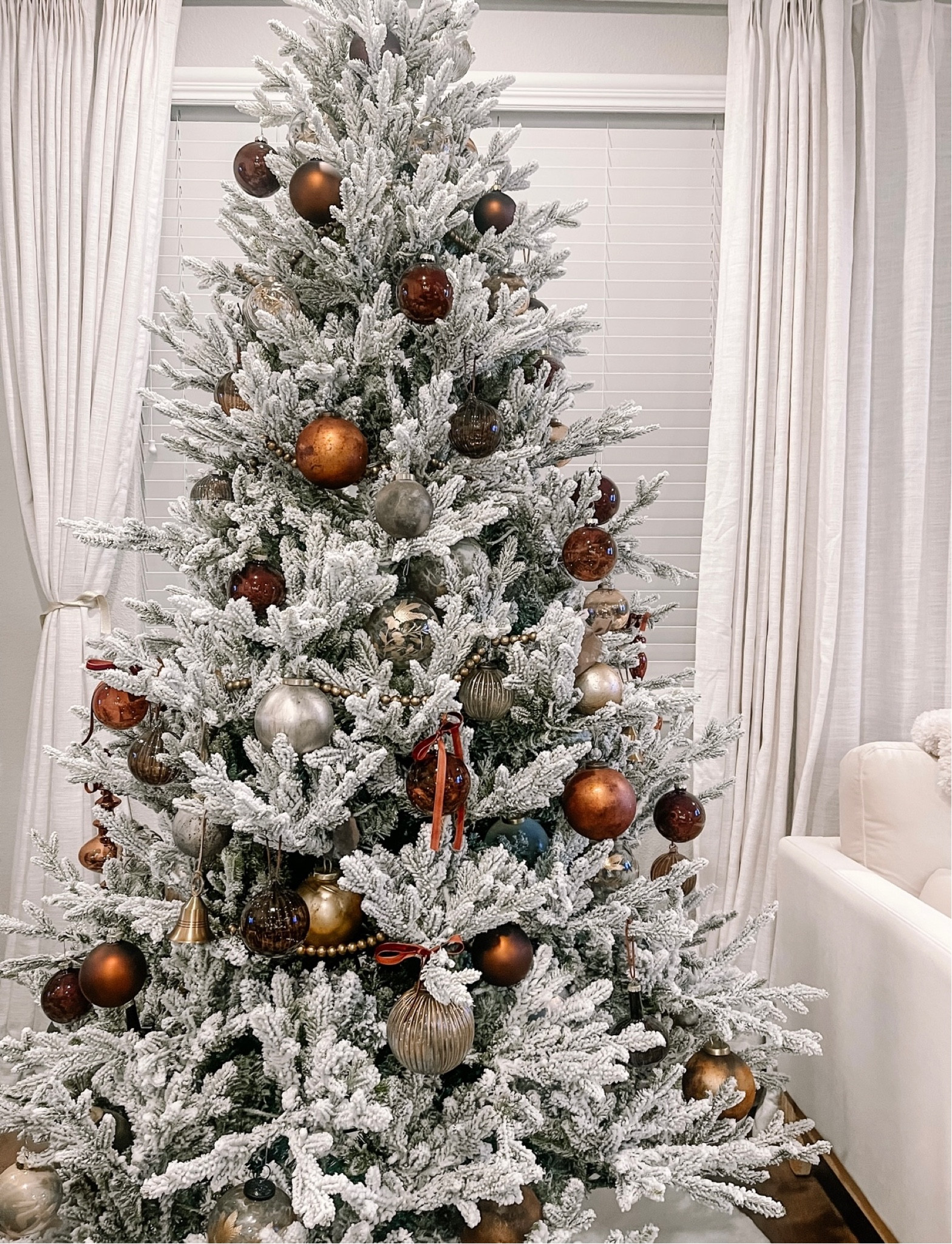 Holiday decor | neutral Christmas tree and decor | white flocked Christmas tree with various brown glass ornaments, brown matte ornaments, velvet ornaments, brown velvet ribbon, gold beaded garland, gold embossed ornaments, gold mercury glass ornaments, studio McGee holiday, McGee and co holiday, pottery barn holiday, pinch pleat linen curtains 

#LTKSeasonal #LTKHoliday #LTKHolidaySale