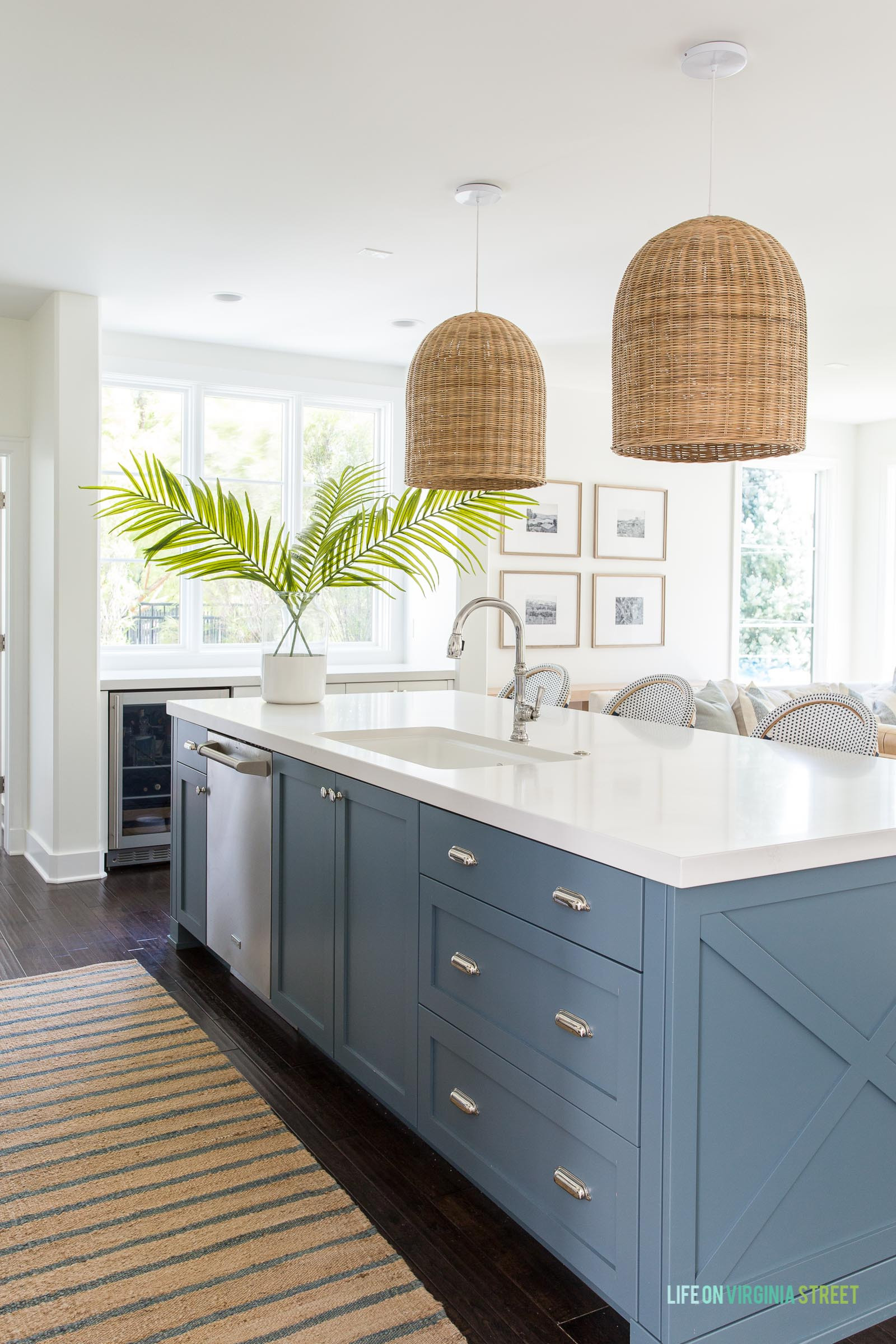 We loved our large size basket pendant lights in our Omaha pool house kitchen! Our white backless counter stools, striped blue runner rug, blue ceramic vase, gold star sconce lights and other kitchen favorites complete the look . Also linking our swiveled armchairs and indoor/outdoor sofa.