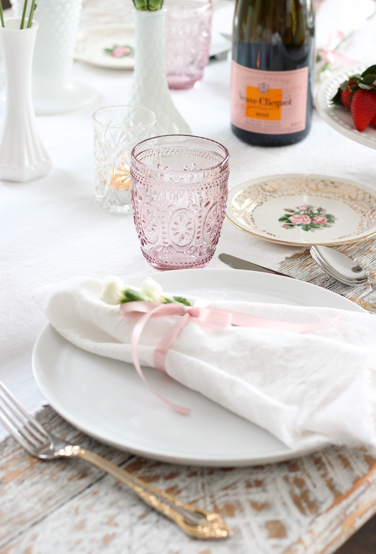 Nothing says love like a sweet Valentine’s Day table setting! Had to start with pretty pink embossed tumblers, then added vintage floral dessert plates. Gold-trimmed flatware and tea lights add a bit of sparkle next to white dinner plates topped with frayed-edge napkins. Grocery store blooms in vintage milk glass vases add a bit of whimsy and charm. Are you celebrating Valentine’s Day at home?

#LTKSeasonal #LTKfoodie #LTKHome