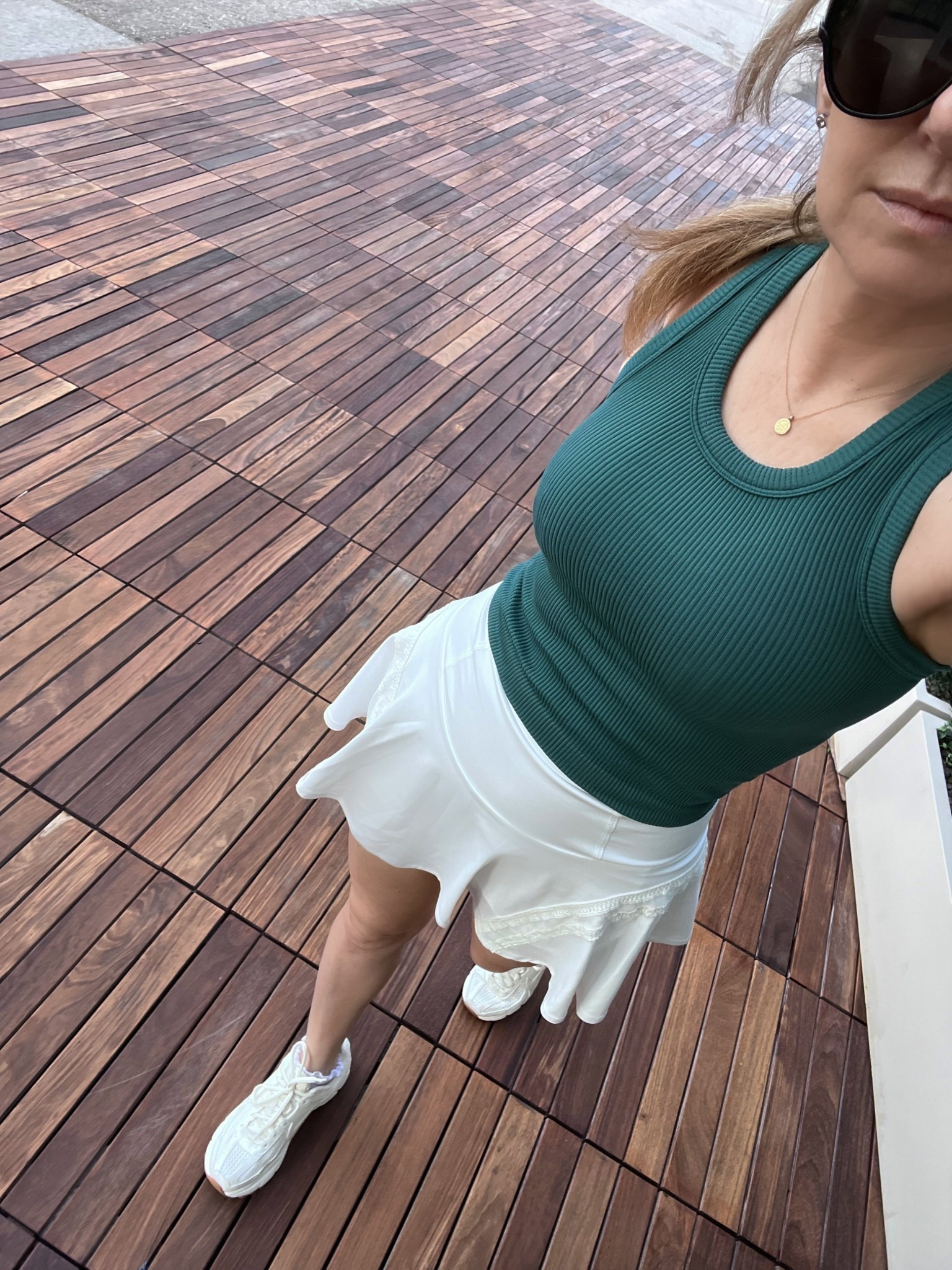 Padel outfit, wearing an evergreen ribbed cropped tank the Regulation Length Pleats and Thank You skort from Free People. The skirt comes in 2 lengths, this is the slightly longer one, both are linked (wearing size: S) Sneakers are Nike Zoom Vomero 5.

#LTKSaleAlert #LTKActive #LTKfitnessgoals