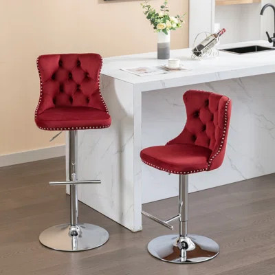 Burgundy velvet swivel bar stools with tufted backs and chrome bases, set of 2
