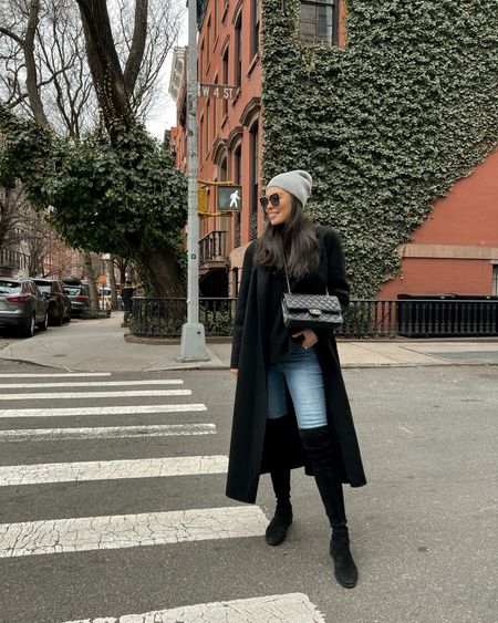 Kat Jamieson wears a winter outfit in NYC. Denim, skinny jeans, over the knee boots, turtleneck, black coat, beanie, Chanel, classic style. 

#LTKshoecrush #LTKSeasonal #LTKtravel