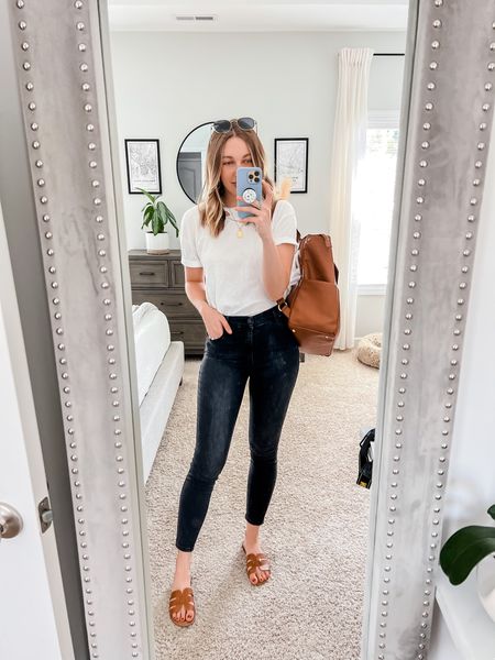 Simple, classic outfit for anyone to recreate from their closet with a white T-shirt, black skinny jeans, cognac sandals and a cognac diaper bag. 

