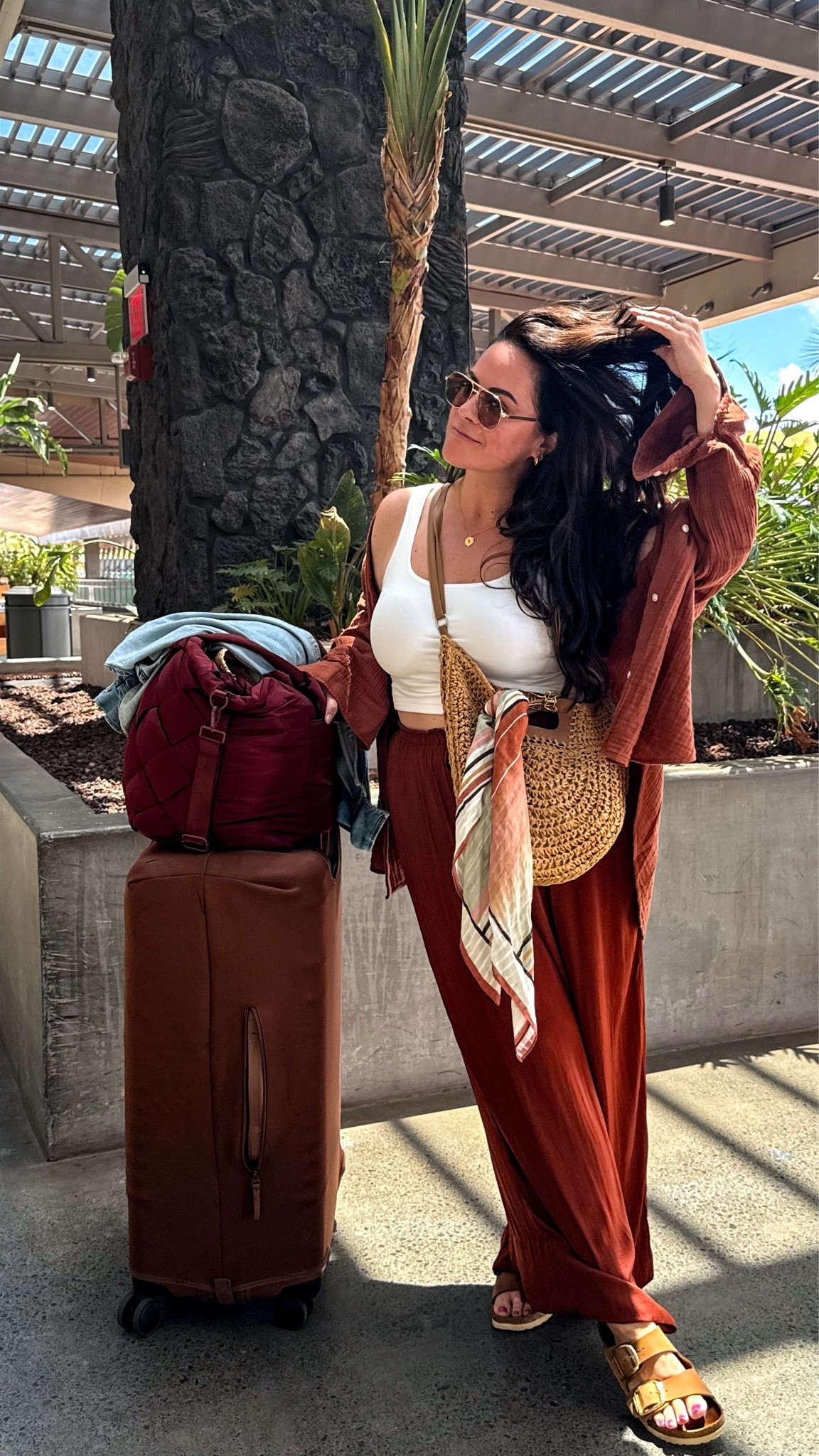 midsize hawaii airport outfit- travel outfit. 

•gauze button down top (runs oversized size large 
•satin flowy pants size large 
•strapless bra 38d (i am typically a 36dd) 
•cropped white tank large 
•my fave birkenstocks tts 
•crossbody straw bag 
•scarf is h&m 
•my fave sunglasses i’ve worn for years 
•travel bag & luggage

#LTKOver40 #LTKTravel #LTKMidsize