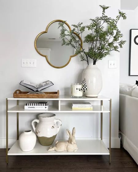 Newly styled living room zane console table from west elm. I’m linking a similar table in case this one sales out. Pottery barn vases, bunny statue, acrylic bookstand, and woven tray. Chanel coffee table book, target mirror, jo malone big candle && mackenzie childs vase climber rabbit.

#LTKfindsunder100 #LTKstyletip #LTKhome