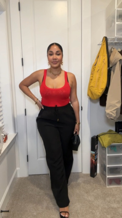 Date night outfit idea featuring black wide leg trousers with side stripes and a drawstring waist paired with a red knit tank top for a bold, effortless look. Styled with a leopard print bra layered underneath for a subtle statement, strappy black heels for added height, and my favorite mini Clementine bag from The Horse.

Slick back bun, everyday gold jewelry, and my go-to fragrance combo — Prada Paradoxe Eau de Parfum mixed with Dossier Floral Marshmallow Perfume — finished the look perfectly. Topped it off with my current favorite gloss, Patrick Ta Major Moisture Smoothing Lip Balm for hydrated, glossy lips.

Perfect elevated casual outfit, date night outfit idea, wide leg pants outfit, sporty chic style, Zara outfit inspo, neutral heels, mini bag styling, spring summer outfit inspiration.

#datenightoutfit #ltkstyle #widlegpants #zarastyle #effortlessstyle #momstyle #springoutfits #dateoutfit

#LTKootd #LTKgrwm

#LTKootd
