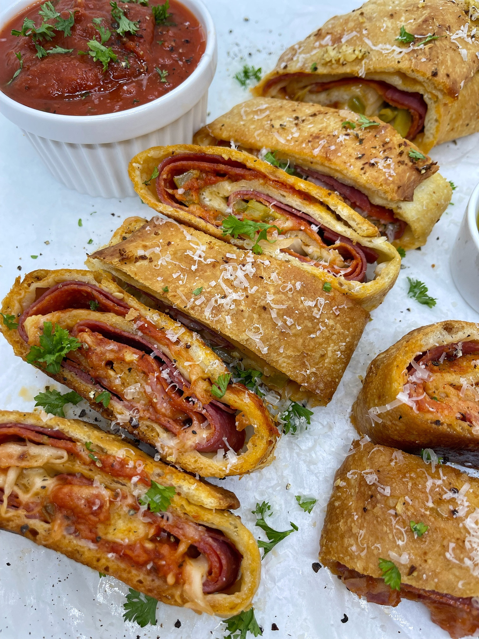 ITALIAN STROMBOLI

INGREDIENTS 
1 cup olive oil
5 garlic cloves, minced 
1 bag of fresh dough from @publix 
Salt, cracked pepper, Italian seasoning 
15 slices of @boarshead_official salami
15 slices of @boarshead_official pepperoni 
5 slices of @boarshead_official ham, diced
1/2 green bell pepper, sliced
1/2 white onion, sliced 
2 1/2 - 3 cups of mozzarella, shredded 
3 cups marinara sauce 
1/2 cup of parmesan, grated 
2 tbsp fresh parsley, chopped 

DIRECTIONS 
1. Preheat oven to 400F. 
2. In a small bowl, combine olive oil and garlic. Mix well. 
3. Remove dough from bag and season. Knead until seasoning is evenly spread. 
4. Add dough to a baking sheet lined with parchment paper. 
5. Roll out dough into a large rectangle and brush with the garlic oil. 
6. Layer on salami and pepperoni, evenly spread ham. 
7. Add peppers and onions to one side.
8. Add mozzarella and dollops of sauce. 
9. Roll up tight making sure to tuck in the edges. Square off edges. 
10. Brush with garlic oil, top with cracked pepper/salt and bake for 25-30 minutes or until fully baked and golden. 
11. Let rest 5 minutes, sprinkle on grated parmesan cheese and fresh parsley. 
12. Slice and serve with garlic oil and sauce.

Baking sheets, rubber brushes, rubber butter brushes, silicone brush, basting brushes 

#LTKunder50 #LTKfamily #LTKhome