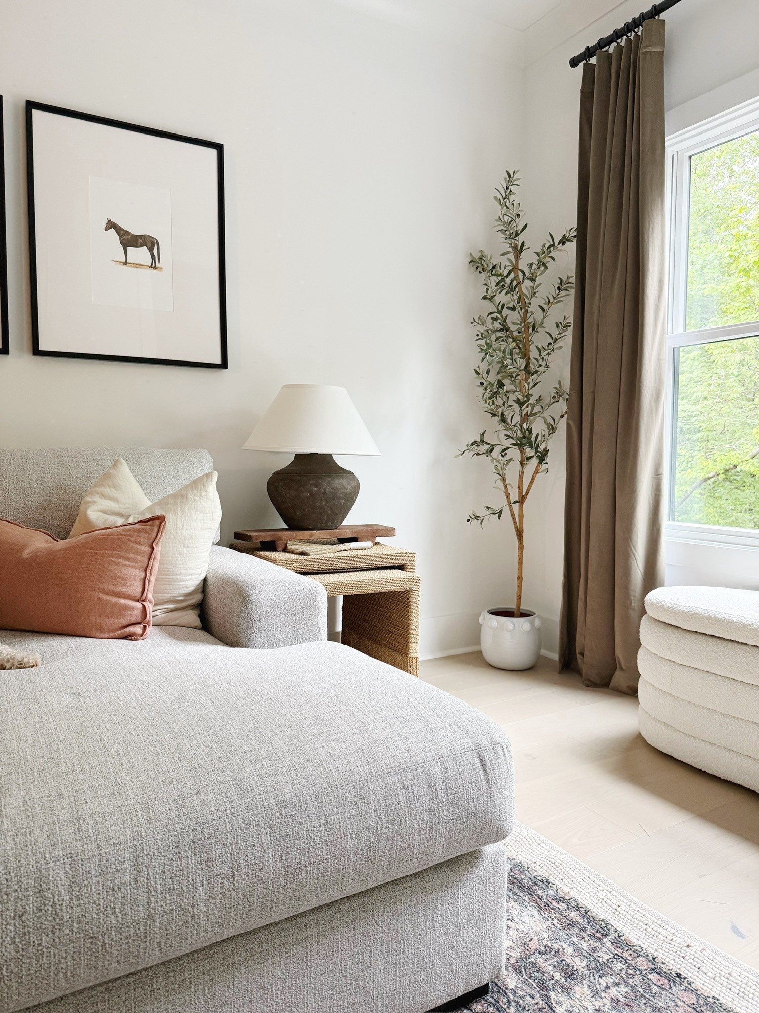 Modern classic feel 🤍 Loving the clean look of this white sectional paired with woven nesting side tables for texture. Vintage black lamp adds character, and the vintage horse photos= Timeless. 🤌🏼Cozy, curated, and totally livable 🖤 #LivingRoomStyle #ModernClassic #CozyVibes #LTKhome #porcheandco

#LTKStyleTip #LTKHome