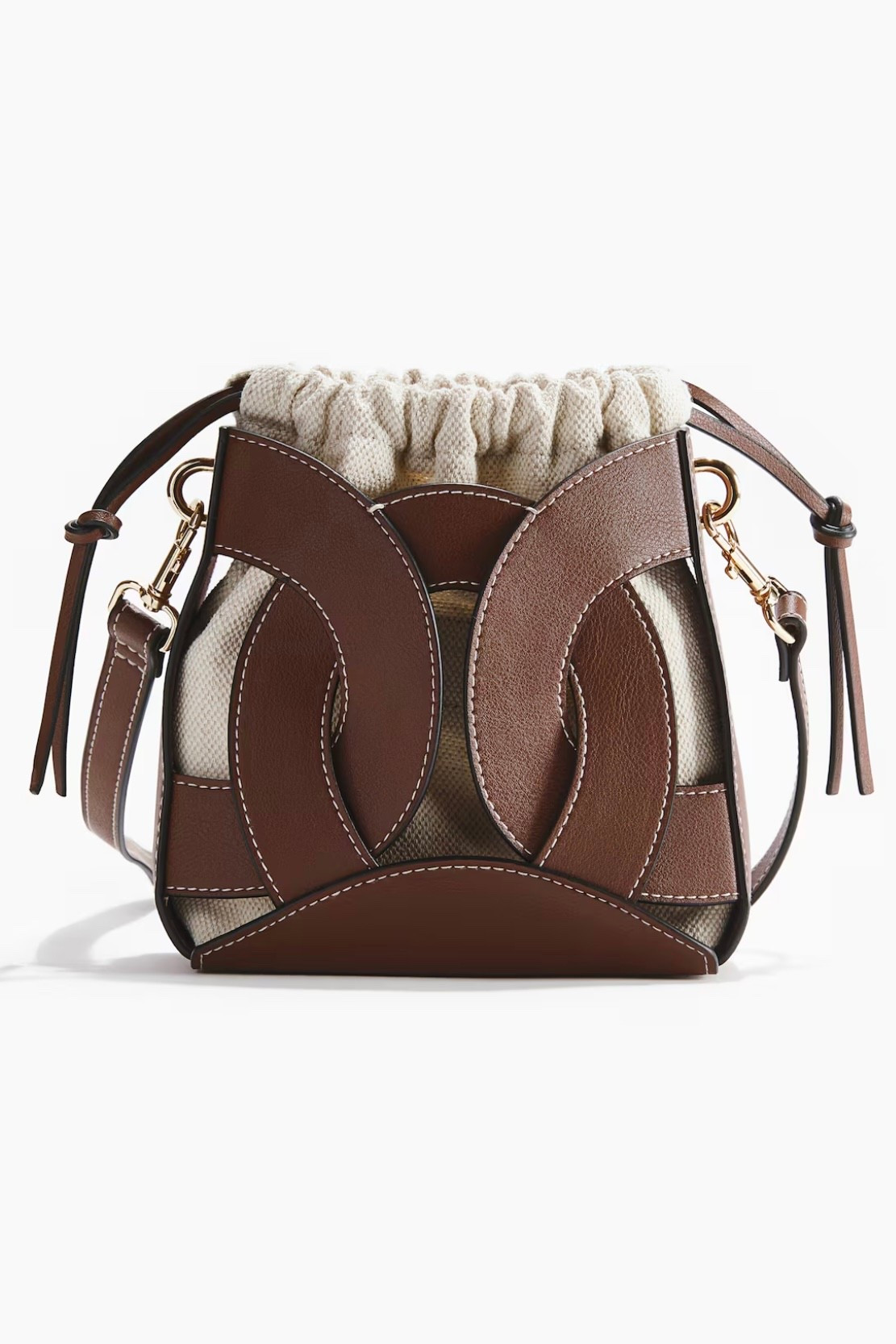Brown leather + canvas bucket bag
Keeps essentials secure without feeling bulky. Crossbody strap for hands-free use. Neutral tones go with everything—easy everyday bag.

#LTKbag #LTKstyletip