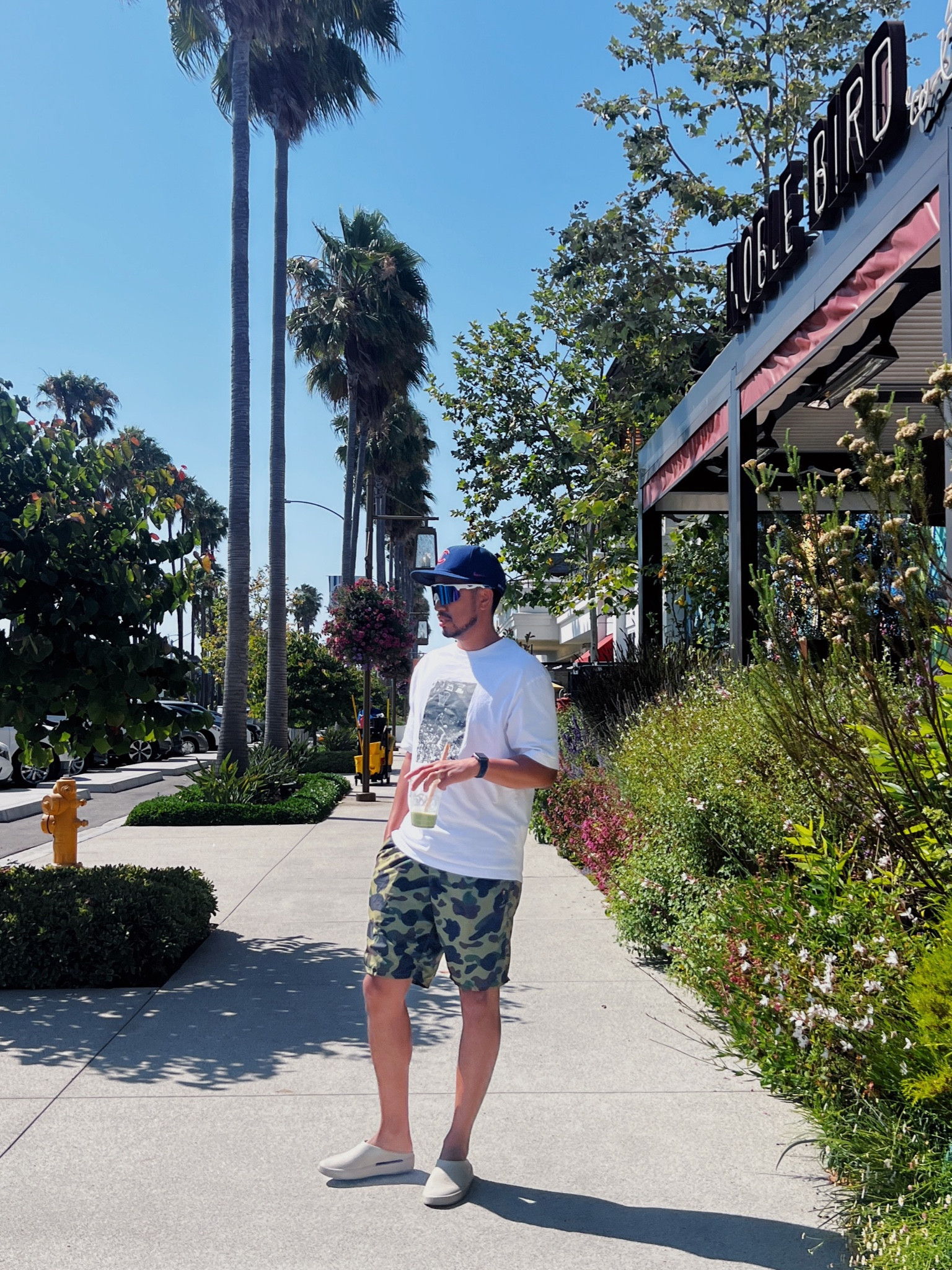 Casual Summer Menswear Look 

beach fashion, men's summer style, Bape shorts, Jordan shirt, streetwear outfit, Cubs baseball hat, Oakley running glasses, Fear of God loafers, California loafers, men's beachwear, summer street style, trendy men's fashion, palm tree beachwear, sporty beach outfit, luxury streetwear

#LTKMens #LTKStyleTip #LTKTravel