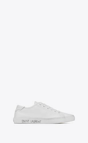 LOW-TOP LACED SNEAKERS with a used look, FEATURING A SAINT LAURENT PARIS SIGNATURE ALONG THE SIDE... | Saint Laurent Inc. (Global)