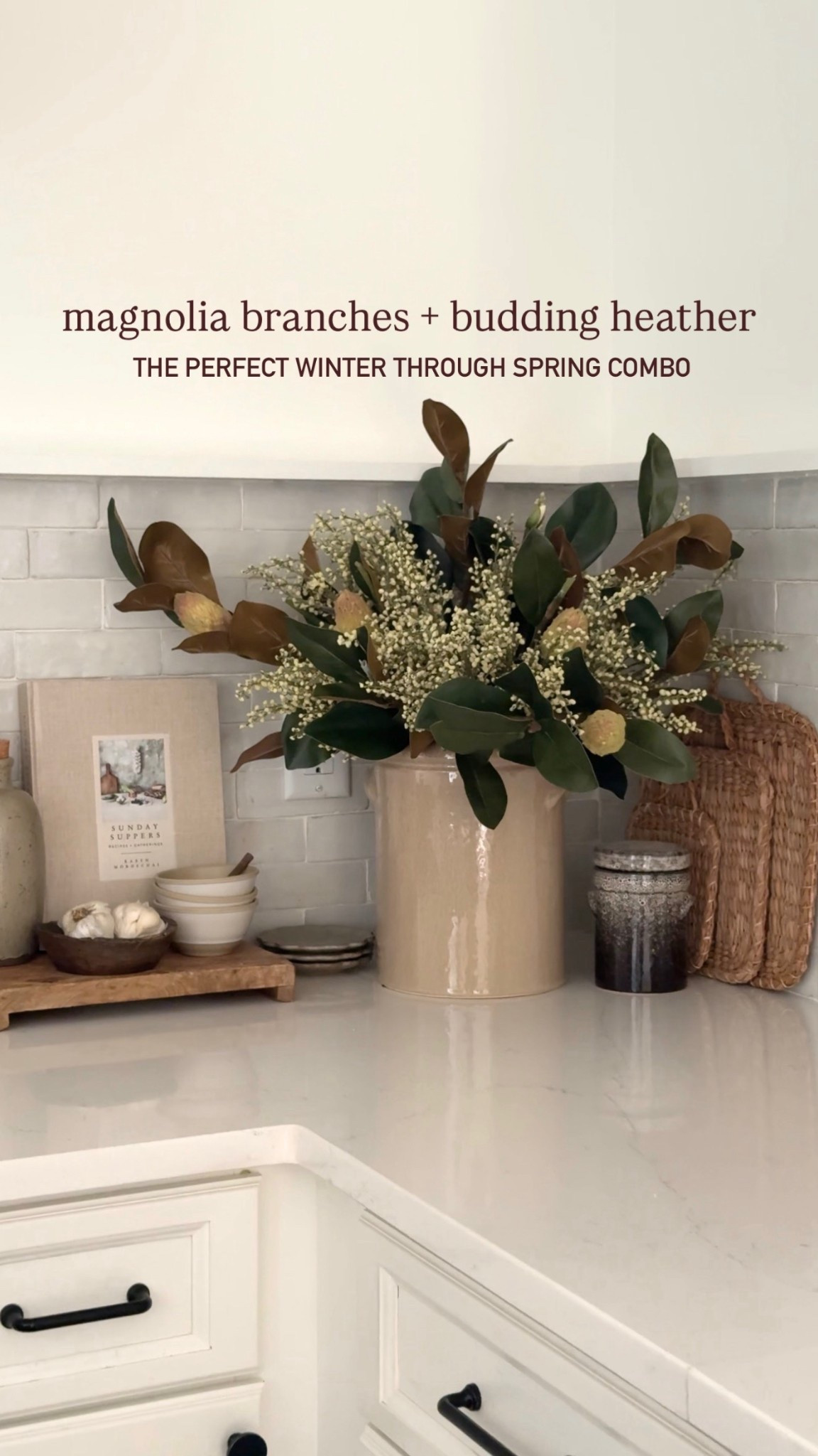 Magnolia leaf branch | budding heather stems | afloral | glossy French crock | vase | winter florals | winter stems | kitchen counter styling | neutral cook books | McGee & co | wood pedestal | wood bowl | spring stems 

#LTKFindsUnder100 #LTKFindsUnder50 #LTKHome