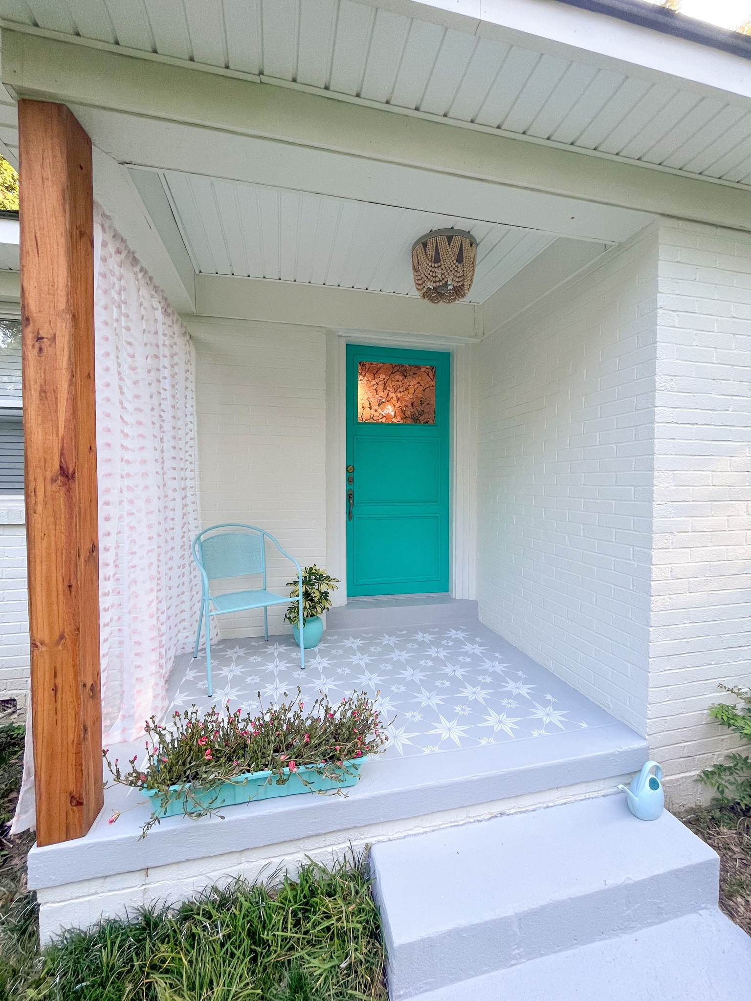 outdoor front door porch makeover diy home project - linked everything i used, including the curtain, chair, stencil, paint, light fixture, and stained glass film

#LTKhome #LTKFind #LTKunder50