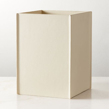 CB2 Nezzo white leather wastebasket, a cylindrical bin