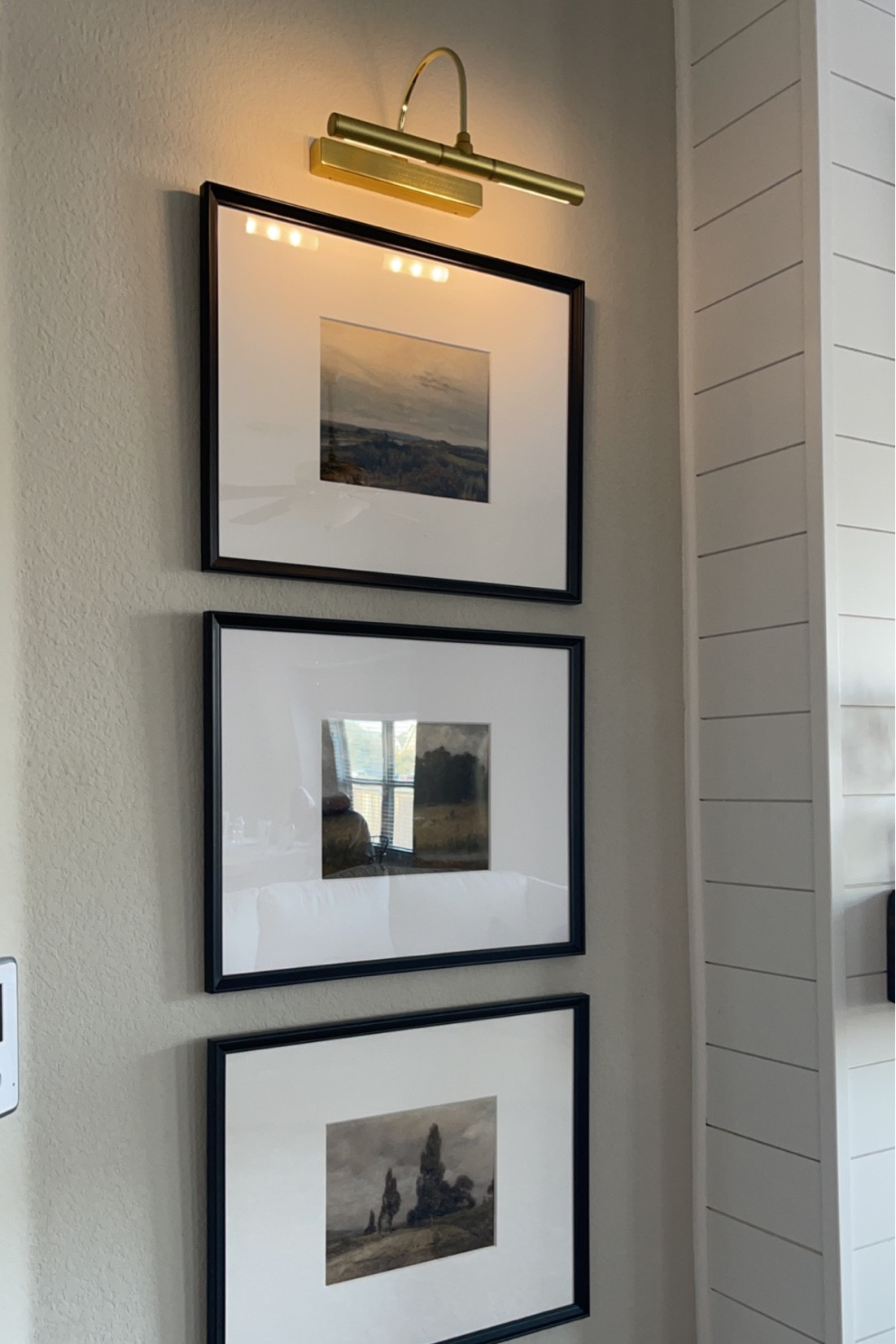 Best Amazon picture light for gallery walls!! Comes in three different colors. We are using gold.
Frames 16x20 with 8x10 mat, from IKEA but linking similar. 
Exact Etsy art linked!! We used a combo of both sets.

Vintage Farmhouse Moody Country Landscape Painting PRINTABLE. 

#LTKhome #LTKFind #LTKstyletip