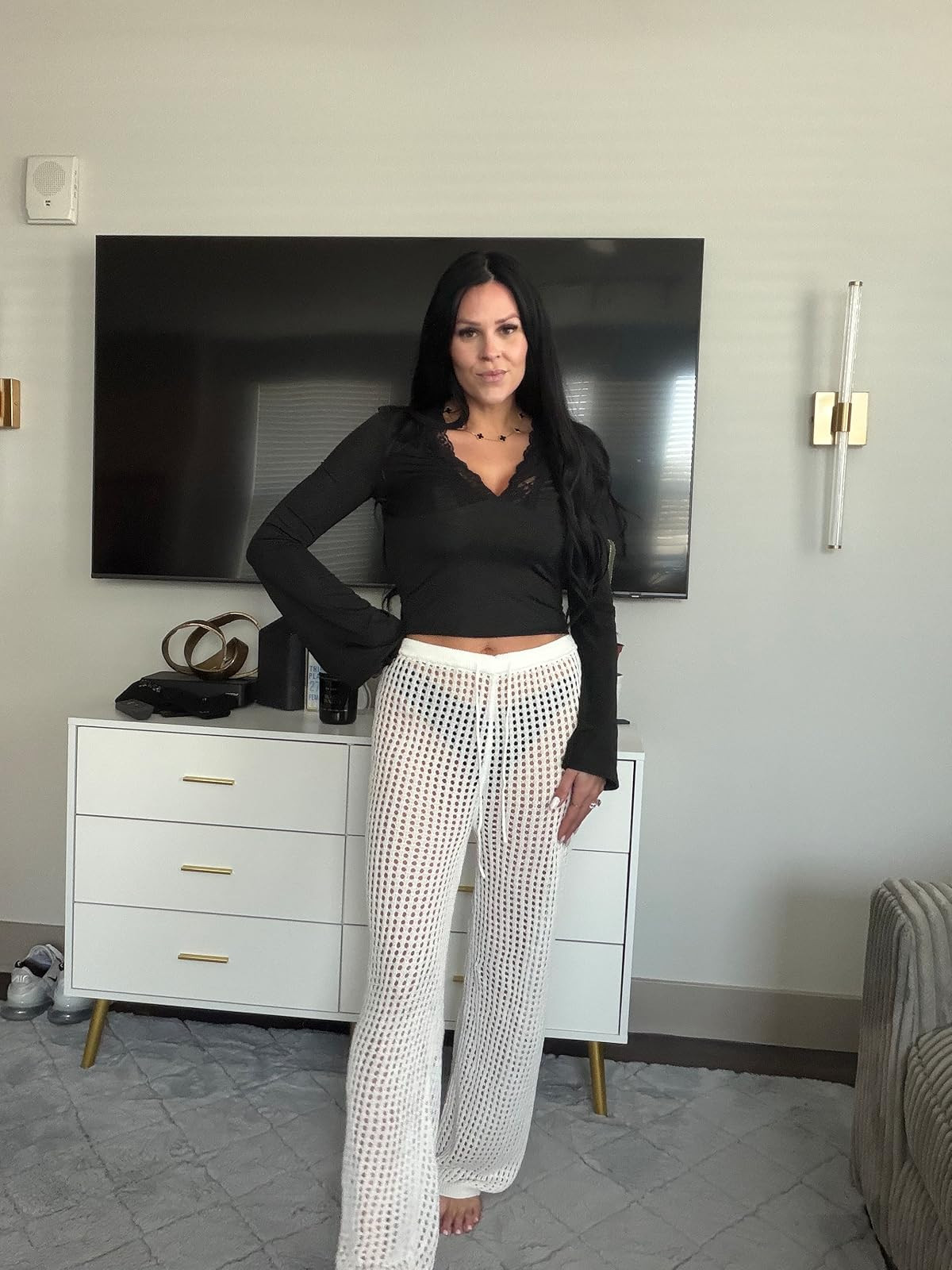 Monochrome mesh. This black lace-trim long-sleeve top paired with white crochet wide-leg trousers is the ultimate effortless beach-to-street look. #MeshStyle #SummerOutfit #LTKstyletip 

 #LTKSpringSale #LTKgrwm #LTKootd