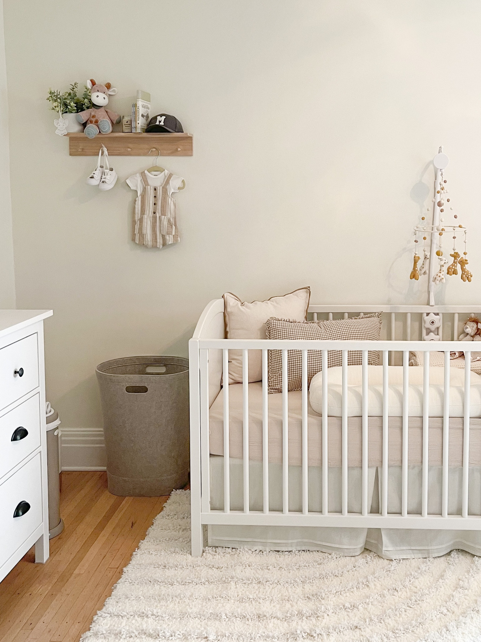 Modern neutral nursery 
Linked crib, mattress, crib sheets, rug, shelf decor, mobile setup, 
Home cozy gender neutral minimal

#LTKbaby #LTKhome #LTKkids
