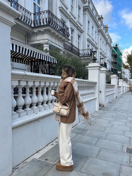 A cold winter outfit of the day. I have to say I love the ice cream tones 🍦🧸☁️🧋These cream wide leg trousers are a great pair of trousers to add to the spring wardrobe. For now, I’m wearing them with chunky knits, an oversized scarf, ultra mini platform uggs and my coach pillow tabby bag. 

#LTKeurope #LTKstyletip