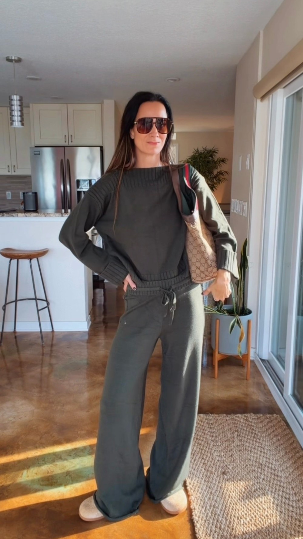 Cozy with a little Gucci on the side. 🤎 An olive knit matching set styled with Gucci slippers, a Gucci tote, and oversized sunglasses. Wear the sweater loose or give it a little front tuck—easy, comfortable, and pulled together. Shop the look below!
