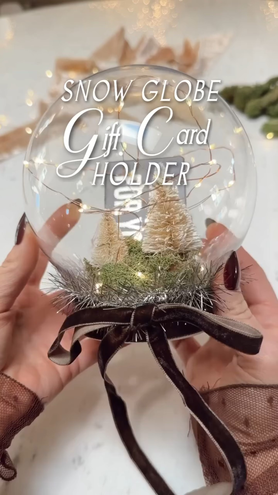 This DIY snow globe gift card holder might be my favorite way to make gift cards feel extra special. It’s so simple to make — just a clear ornament, a little moss, mini bottle brush trees, and twinkle lights. The result feels like a tiny winter wonderland, and it turns a simple gift card into something truly memorable.

diy christmas gift idea, snow globe gift card holder, neutral christmas decor, cozy christmas diy, handmade holiday gift, christmas craft ideas, easy christmas diy, modern cottage christmas, organic modern christmas, cozy holiday home, christmas wrapping ideas, thoughtful gift presentation, pottery barn christmas, anthropologie christmas dupe, scandinavian christmas decor, holiday gift wrapping, creative christmas ideas, cozy minimalist christmas, cottage christmas style, christmas home inspiration

#LTKGiftGuide #LTKSeasonal #LTKHoliday