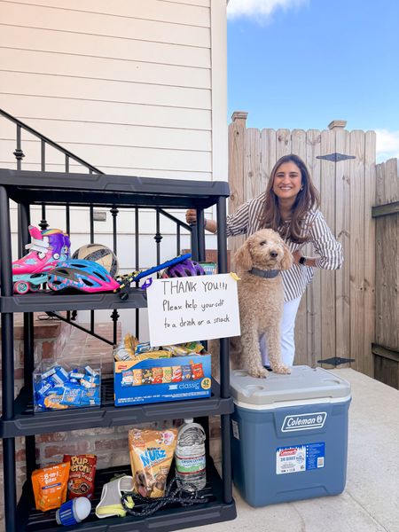 
#WalmartPartner It’s become a bit of a tradition in our home to put water and snacks out for the delivery workers as the weather warms. It took me a minute to set this up, but it’s here. And right now with the construction going on in our backyard, I think it’s perfect timing for all the construction workers to grab something as well. 

Got this 4 tiered shelf to add some snacks, the kids sports stuff and Archie’s treat. Not to mention we finally got a cooler to keep the drinks cool and it’s the kids job to make sure all items stay replenished. I found these items at my local Walmart. And Archie “helped” me set it up. 
Hope this inspires you to do something similar!

@walmart