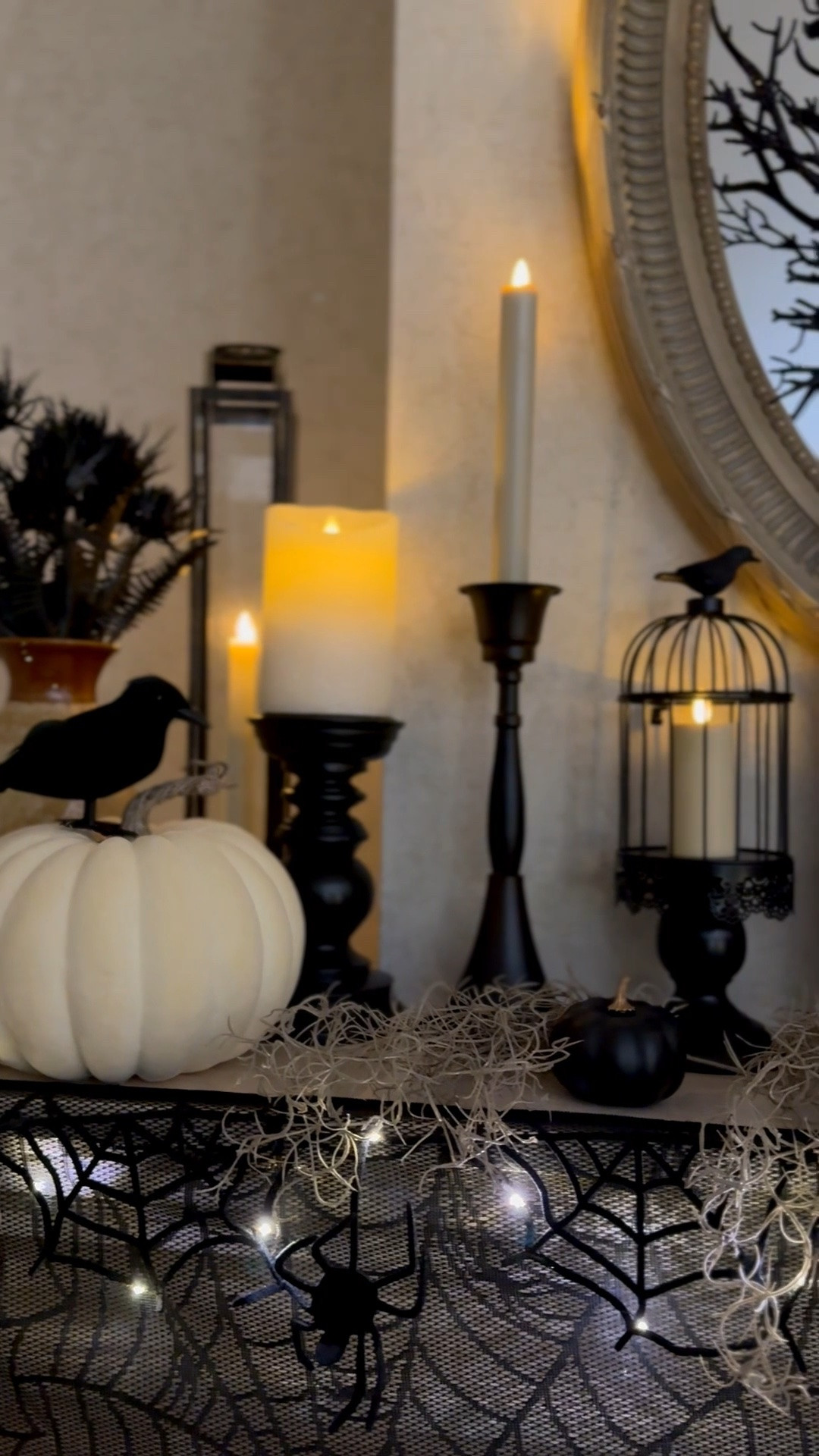Halloween living room mantel decor, black skull candle, decorative crows, Halloween home decor